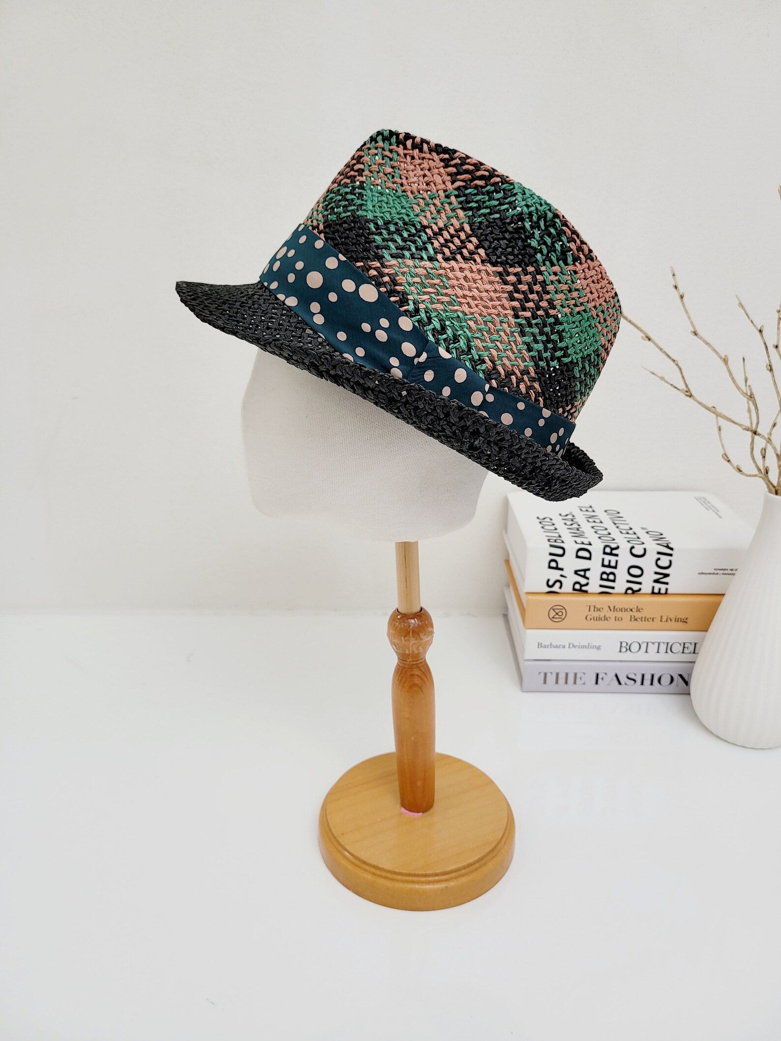 Breezy fedora hat with black brim, patterned green/pink crown, and blue polka-dot band, displayed on a mannequin.