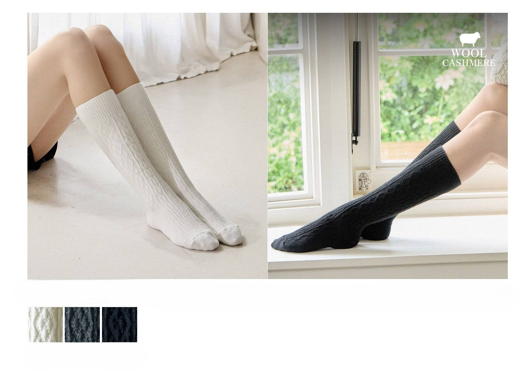Two pairs of socks shown on feet with a window in the background, featuring the Wool Cashmere brand.