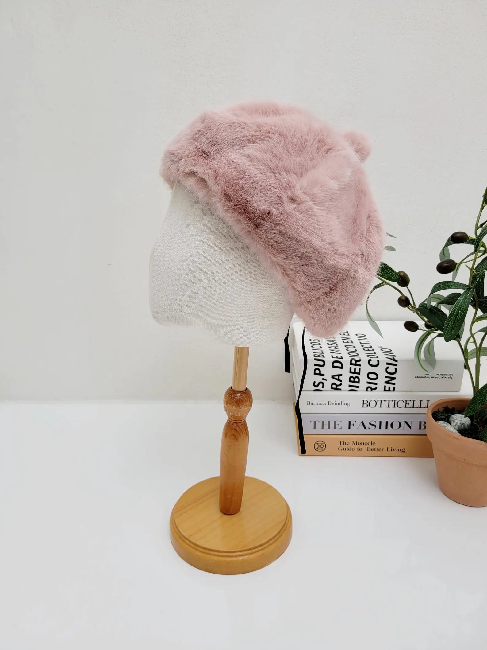 paris in winter pink faux fur beret on a mannequin head. A cute and stylish winter hat.