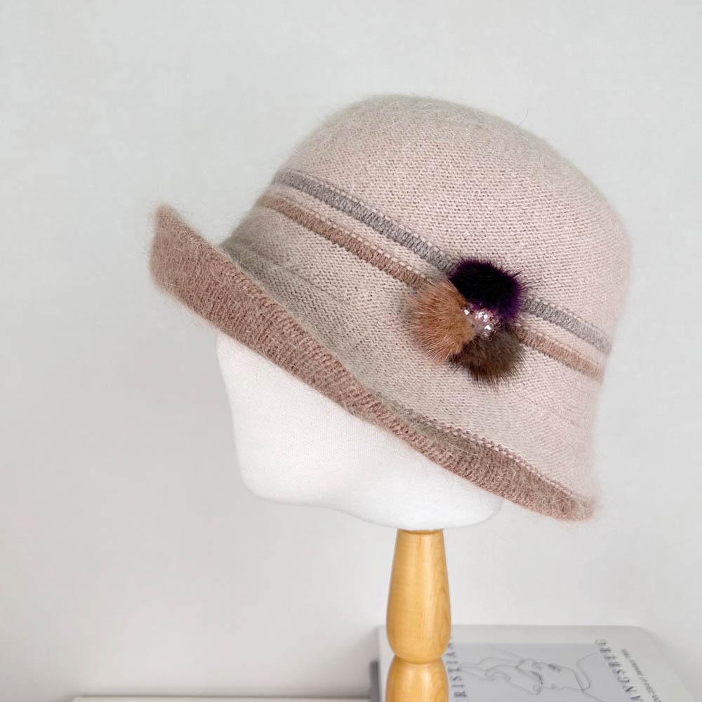 Beige angora elizabeth hat with brown striped band and decorative pompom accent, displayed on a mannequin head.