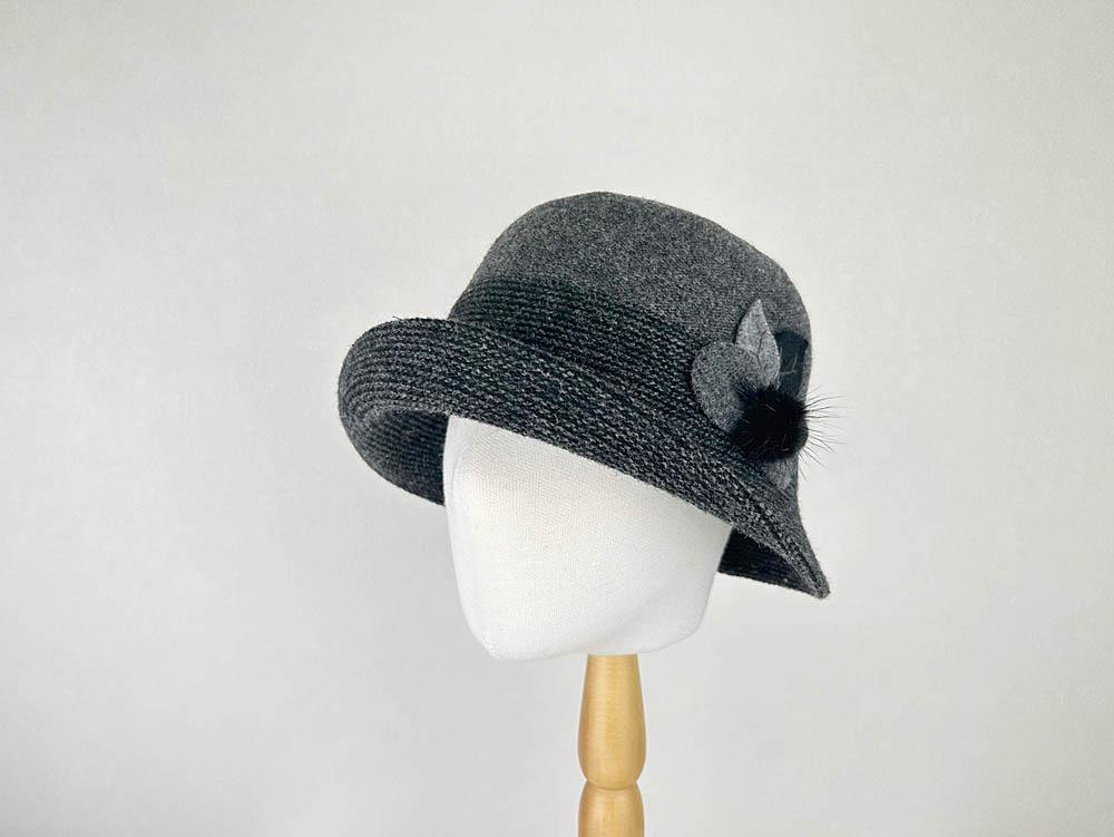 Gray catherine cloche hat with dark textured band detail and flower accent. A stylish vintage-inspired hat.
