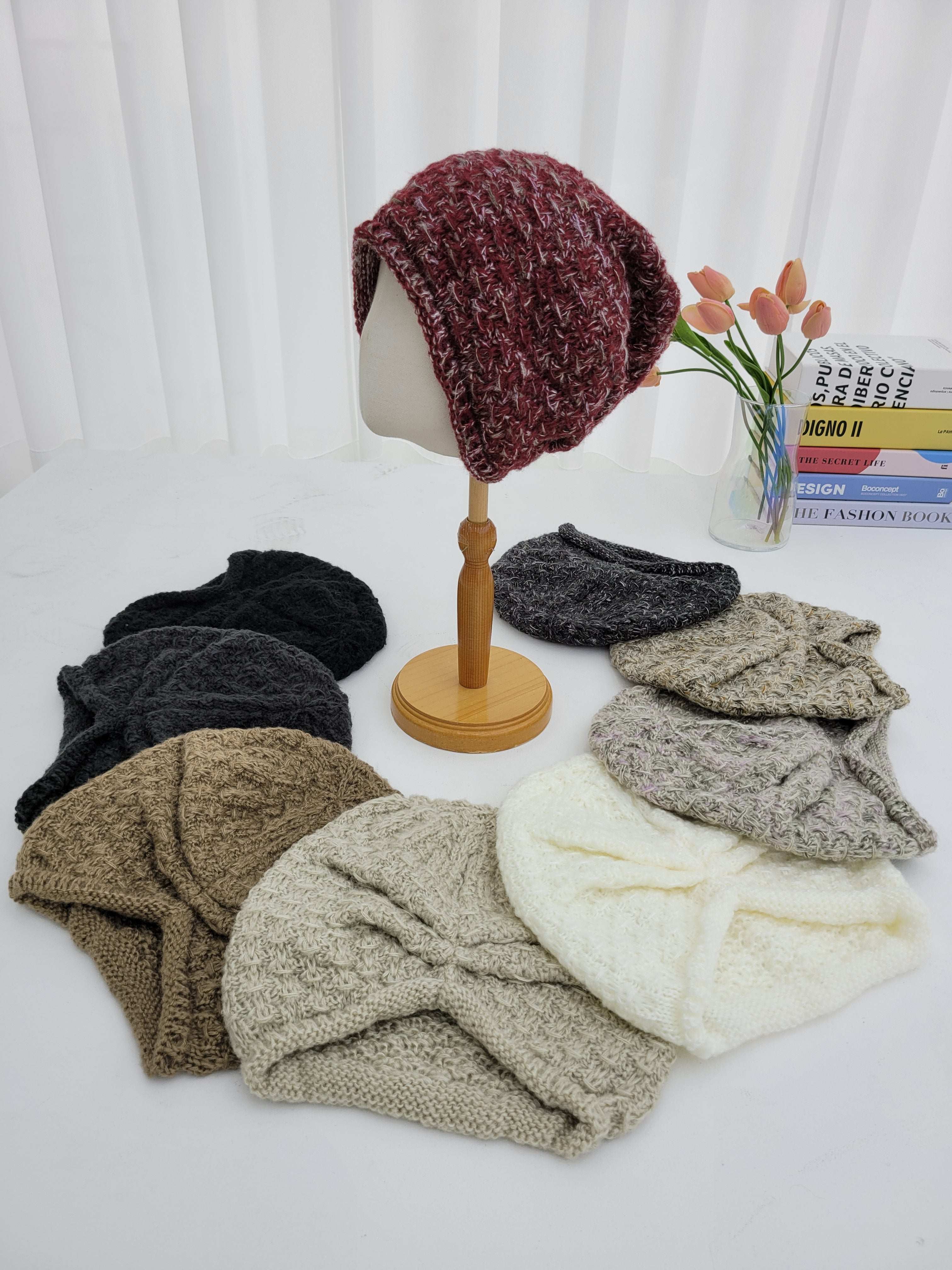 Collection of knitted headbands in various colors on a white surface.
