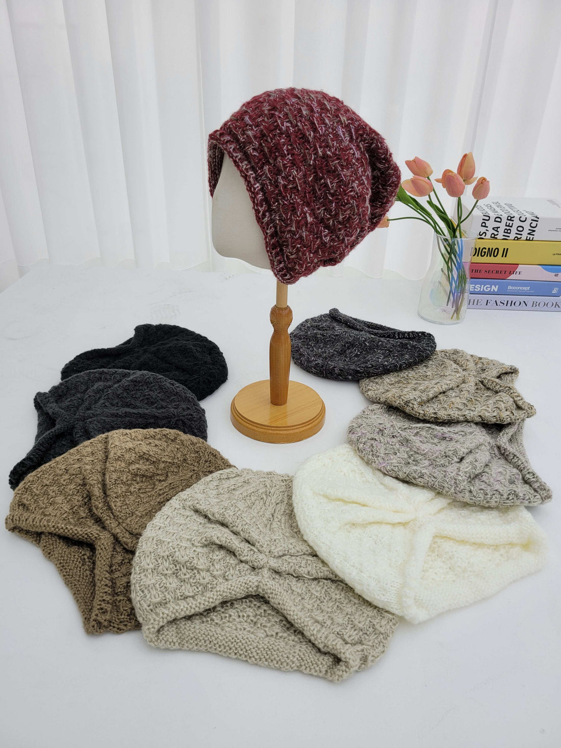 Collection of knitted headbands in various colors on a white surface.