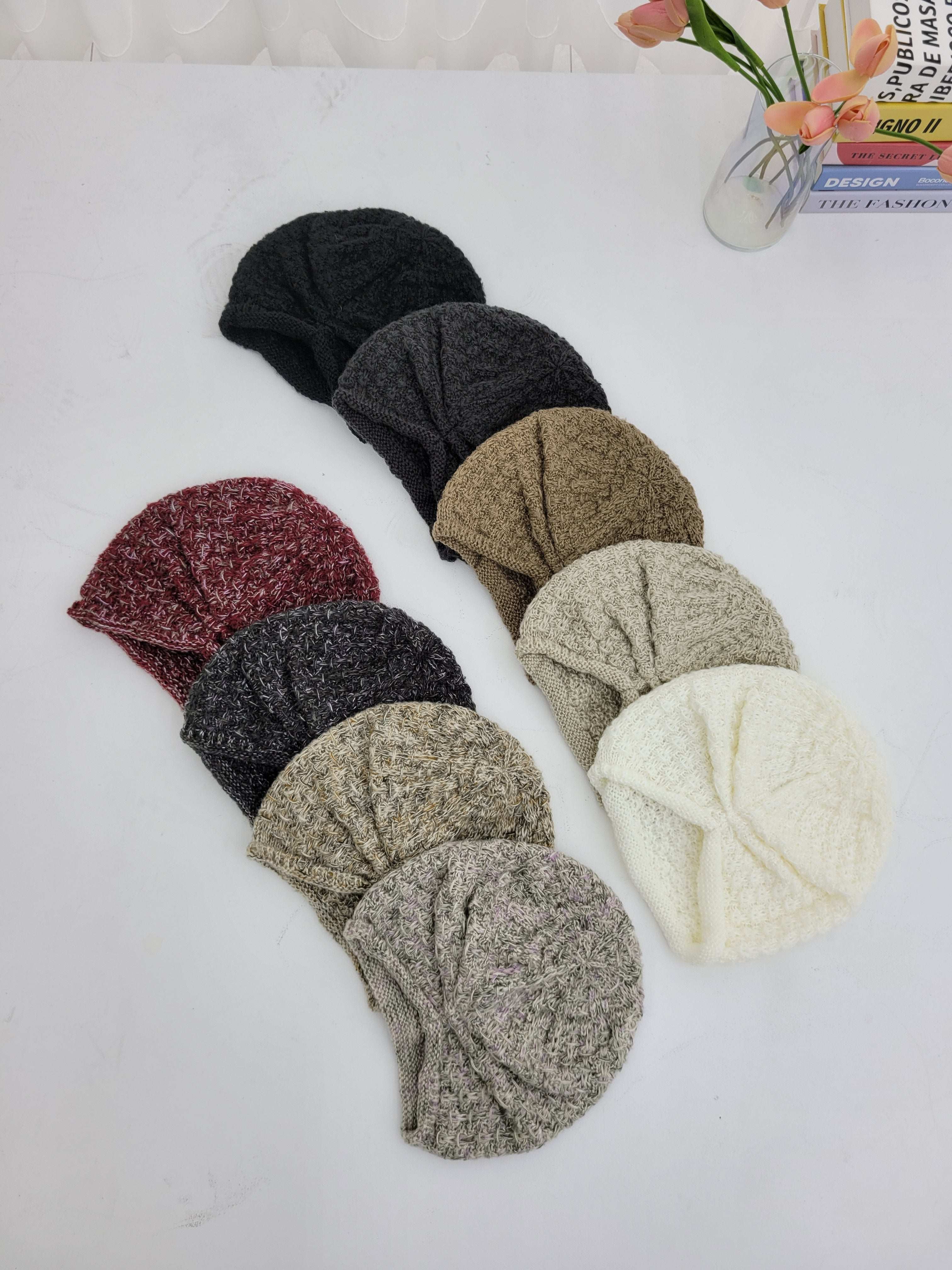 Set of knit headbands in various colors on a white surface