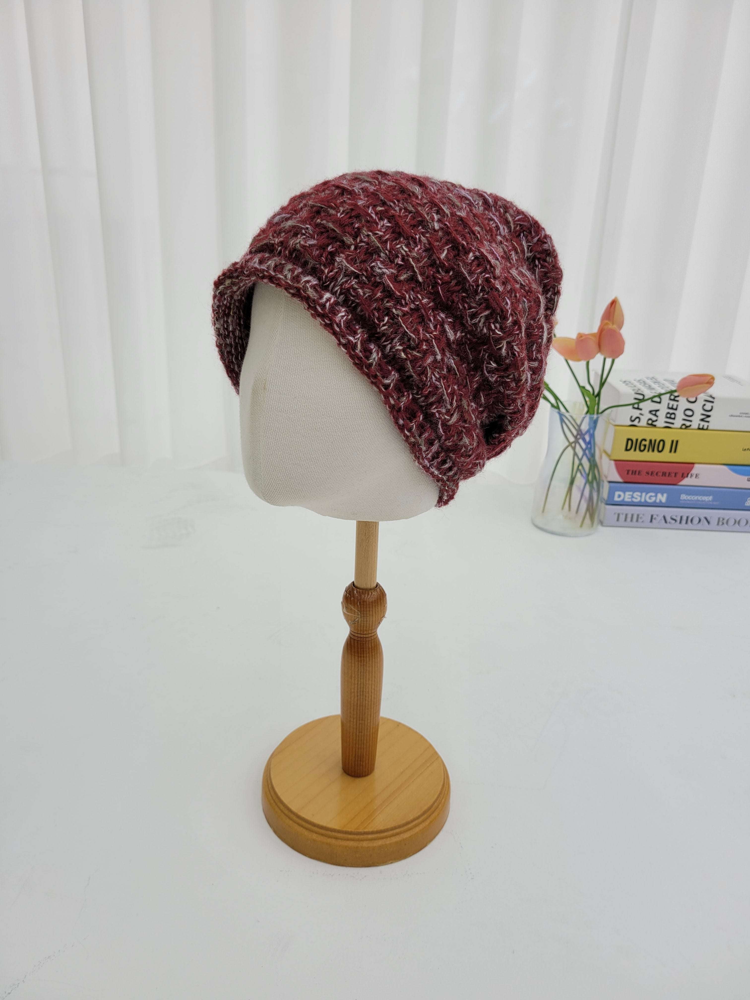 Knitted hat on a mannequin head against a white background