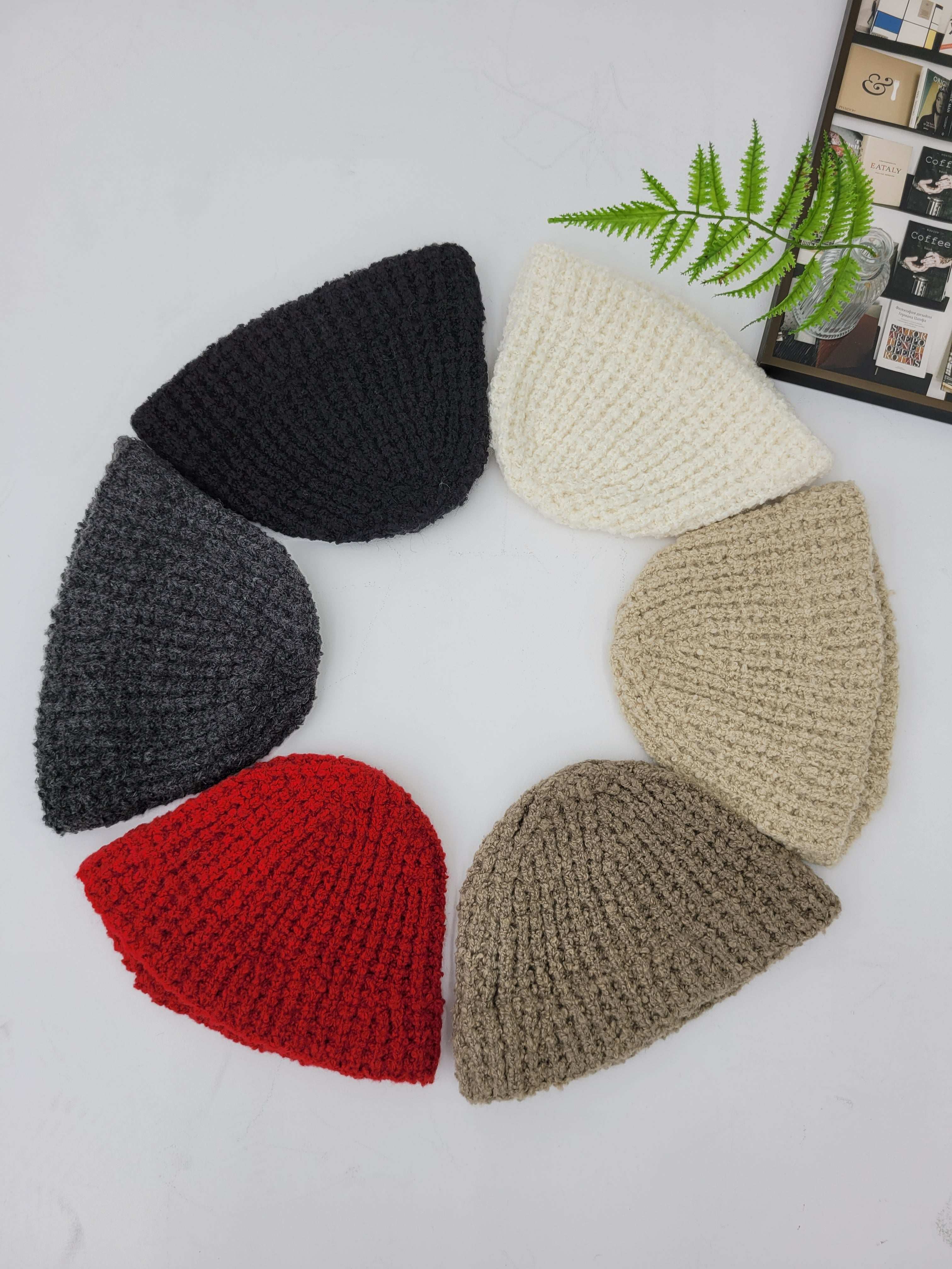 Set of five knitted beanies in beige, black, gray, red, and cream on a white background.