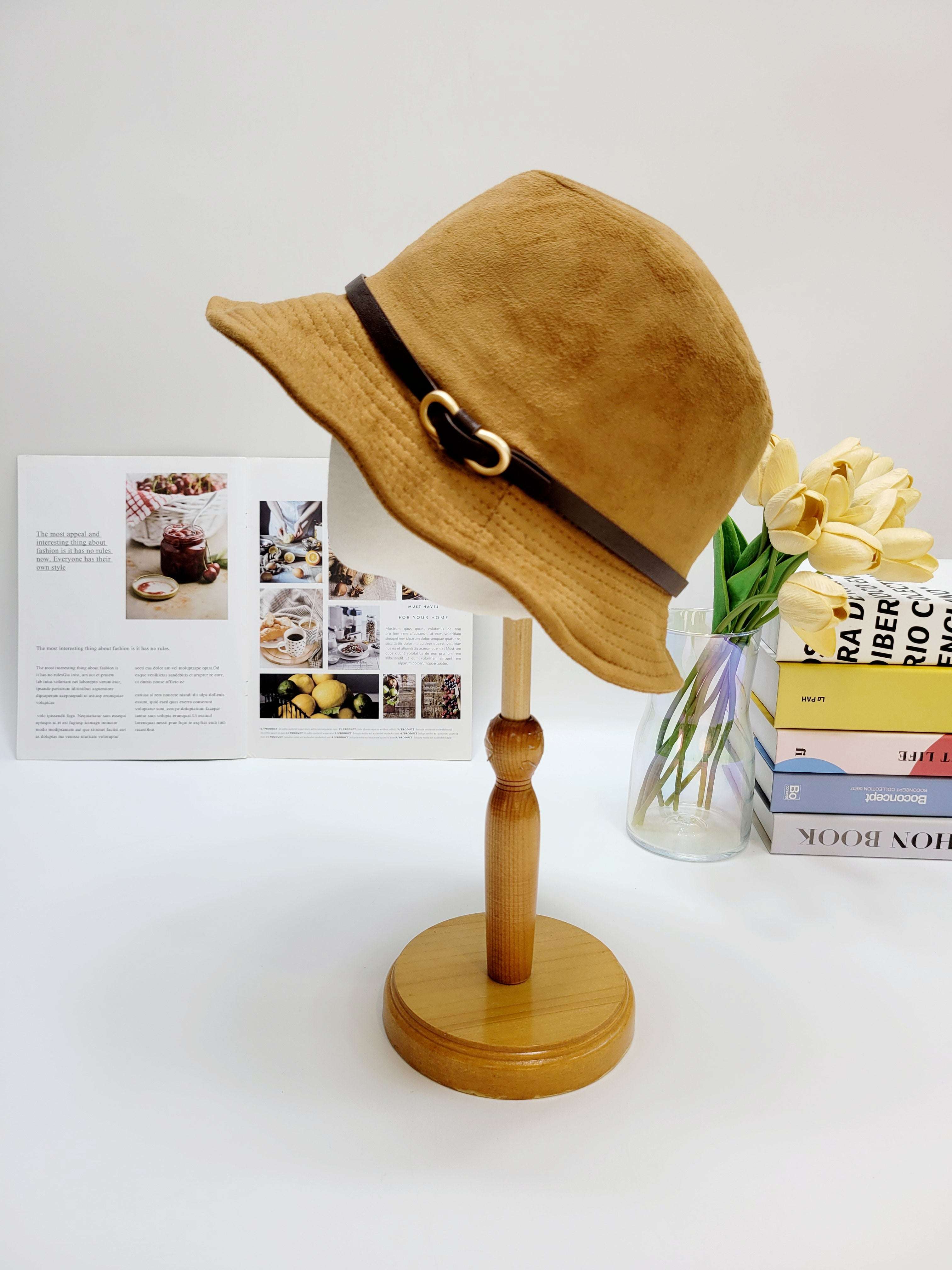Brown hat on a wooden stand with a white background