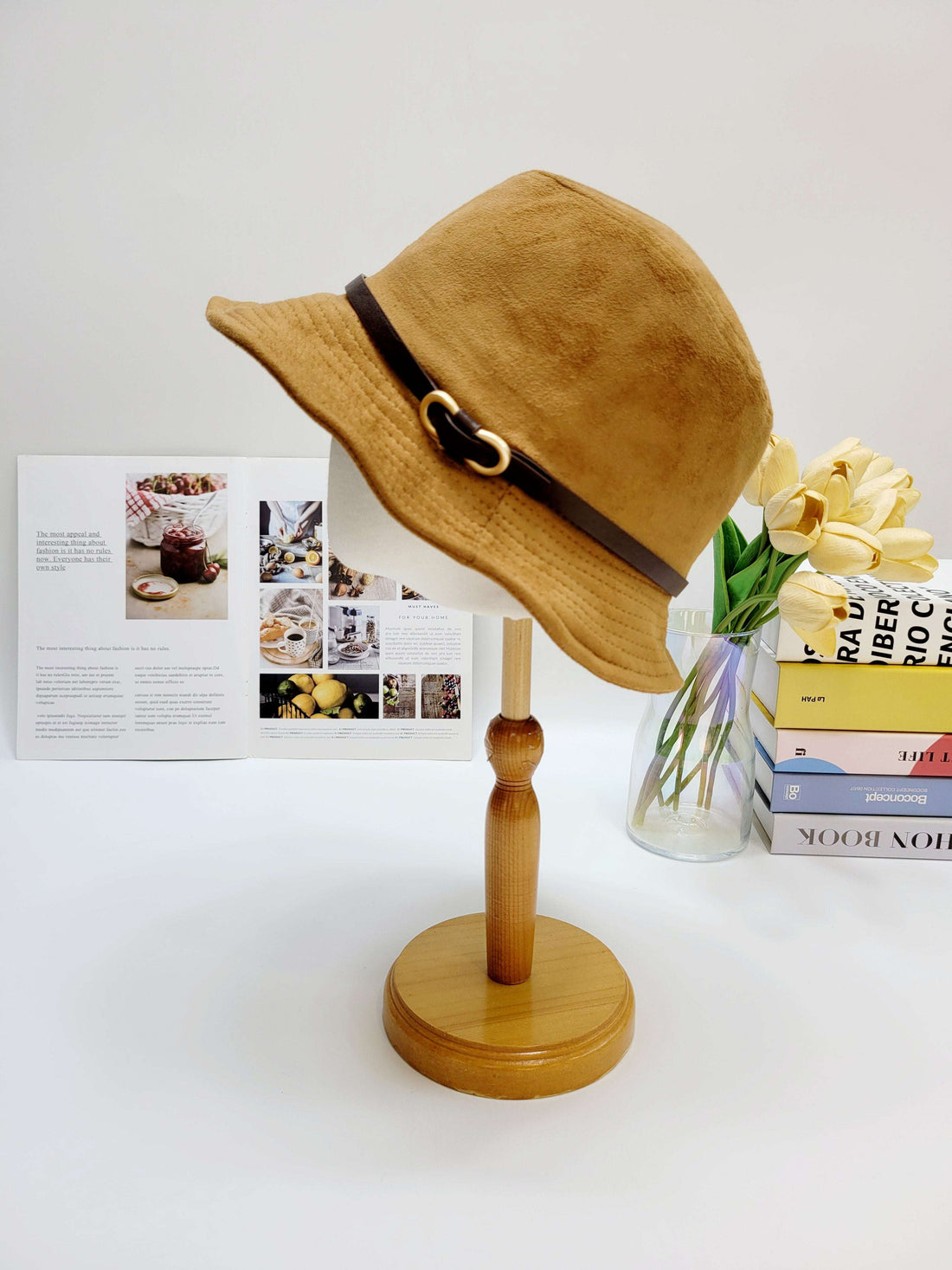 Brown hat on a wooden stand with a white background