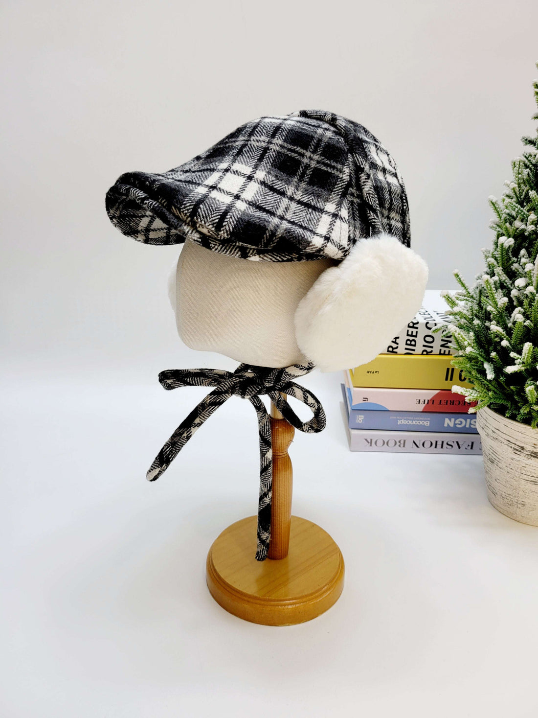 Plaid hat on a mannequin head with a white background