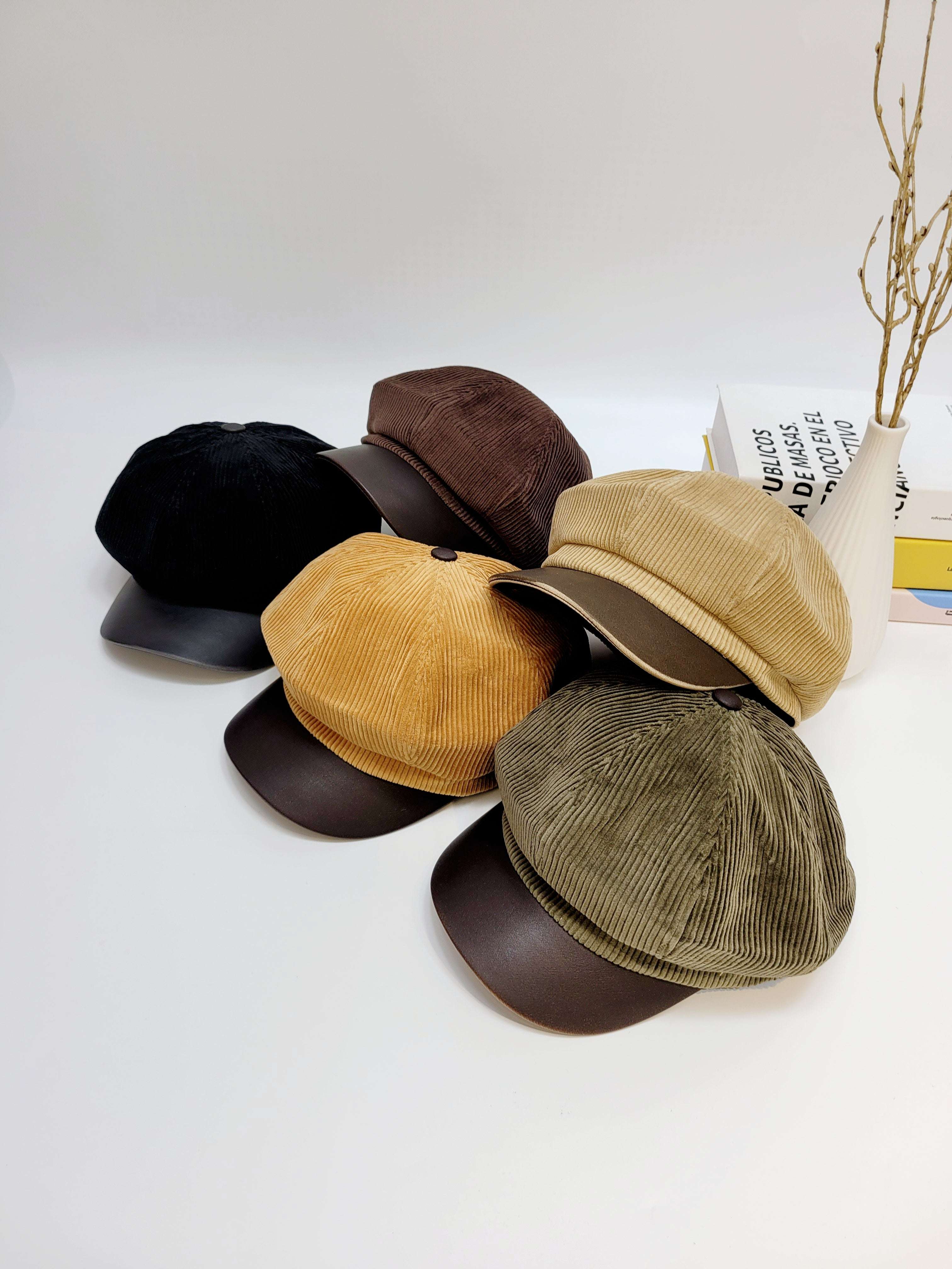 Set of five different colored caps arranged on a white surface.