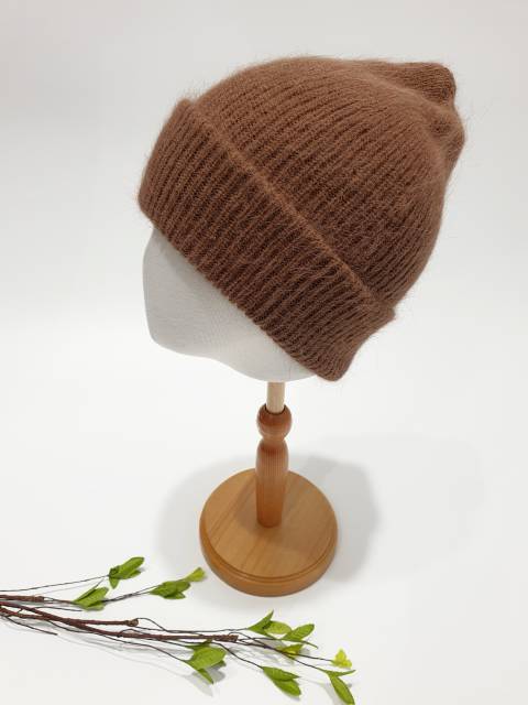 Brown knit beanie on a mannequin head with a white background