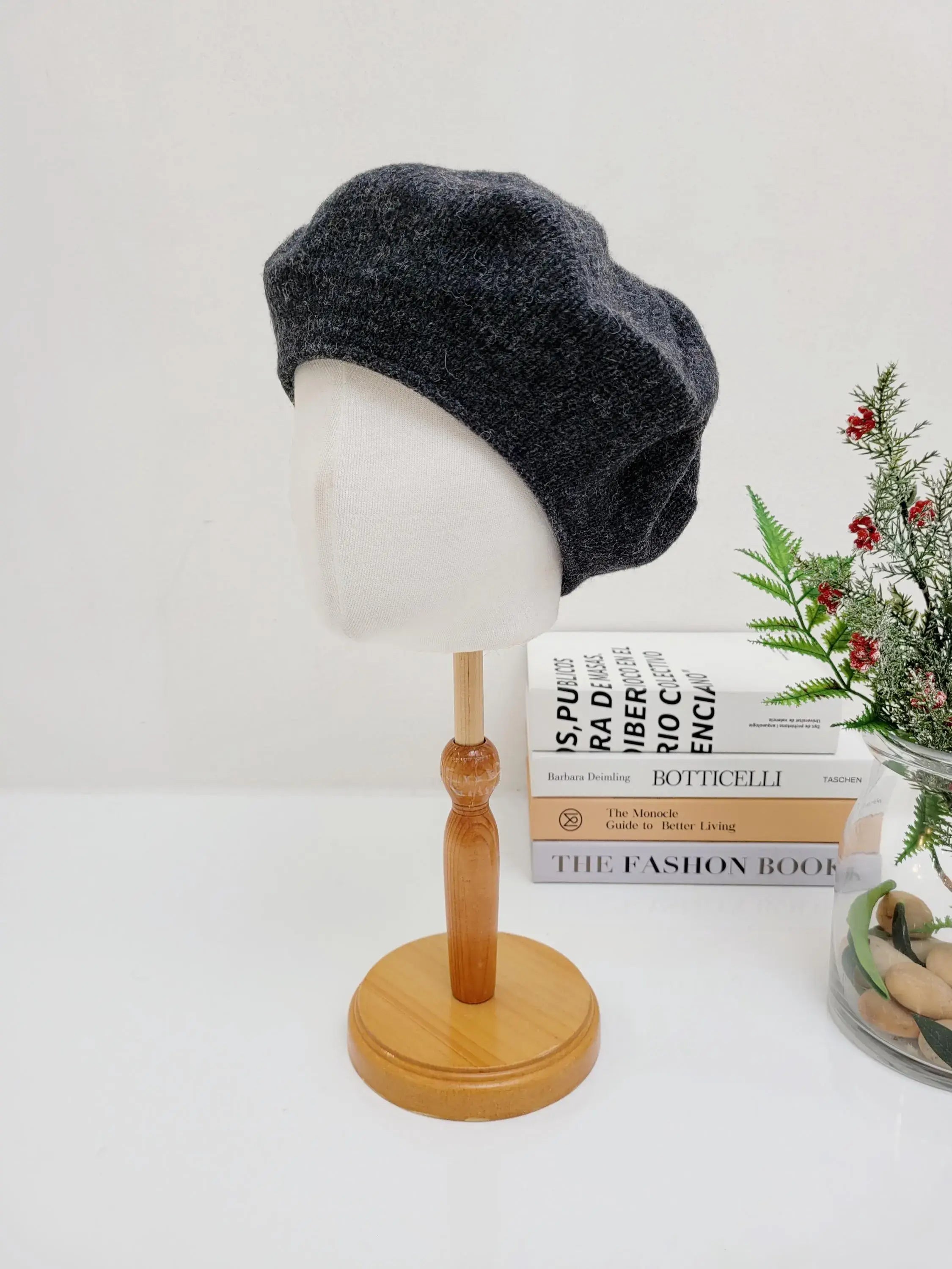 Dark grey paris wool beret displayed on a mannequin head; a stylish and classic accessory.