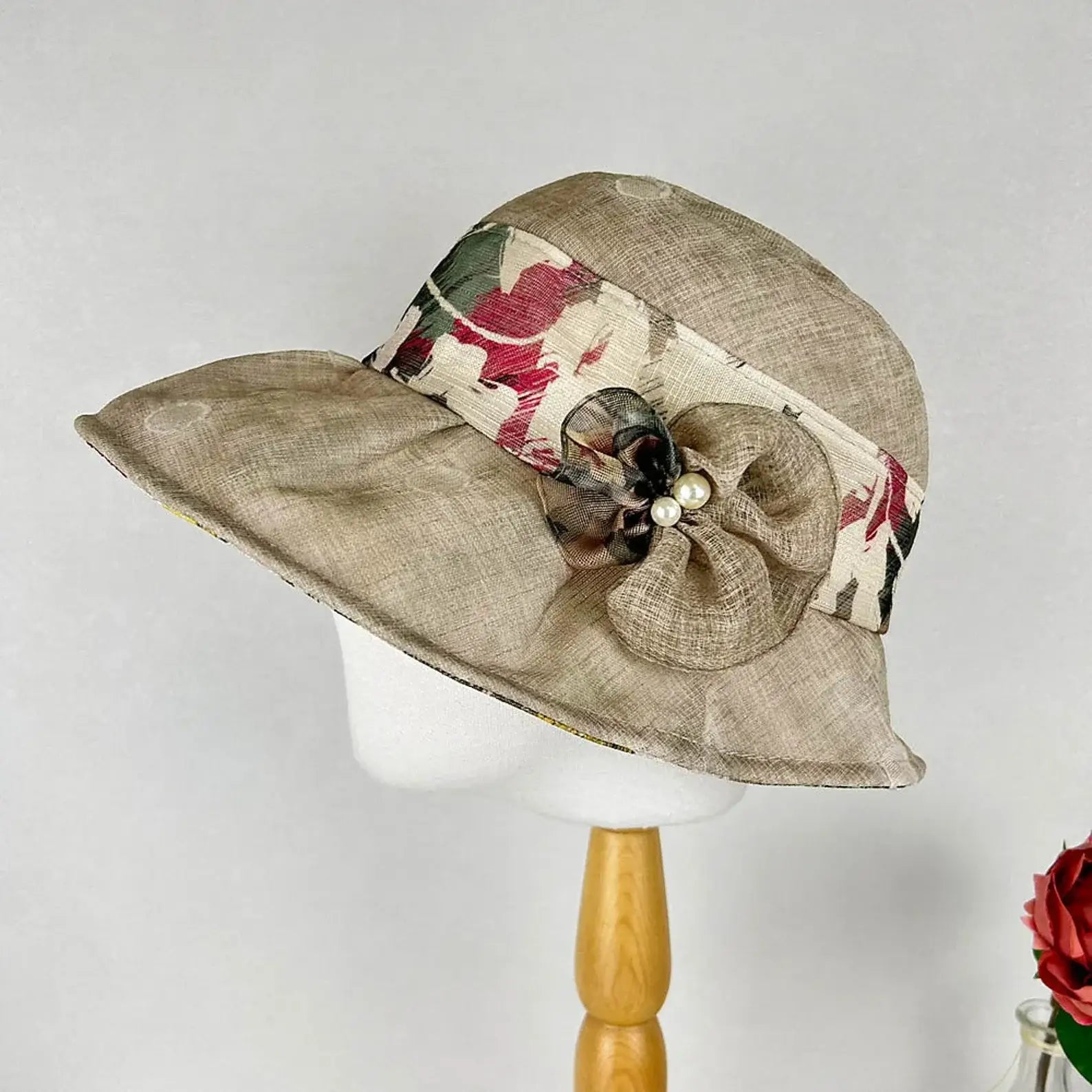 BOTANICAL beige hat with floral band and flower embellishment.