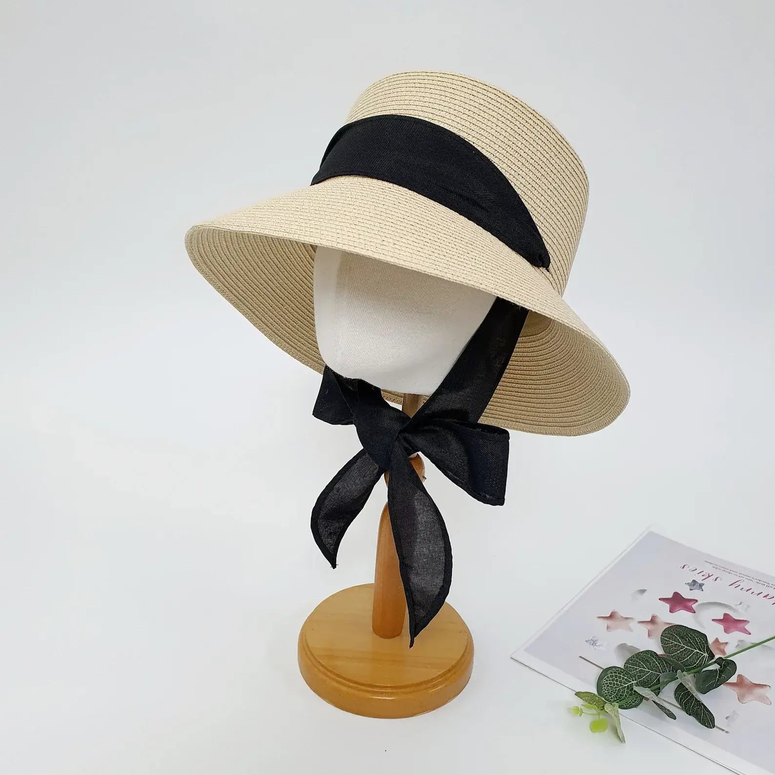 PENELOPE straw sun hat in natural with a wide brim and elegant black ribbon detail