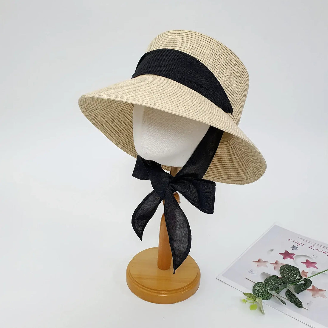 PENELOPE straw sun hat in natural with a wide brim and elegant black ribbon detail