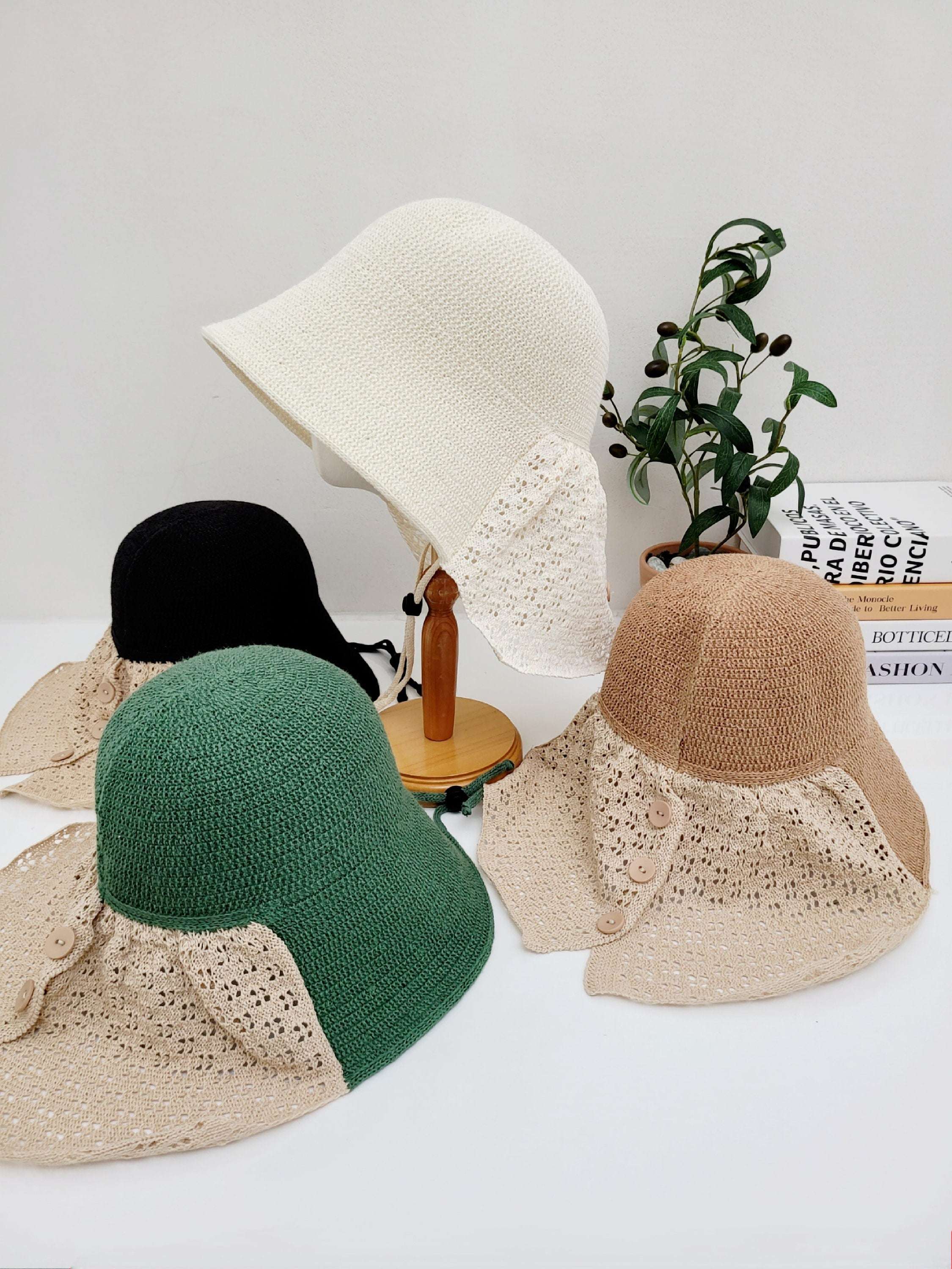 CELINE sun hats: cream, black, green, & brown. Each hat features a solid crown and a delicate lace brim detail.