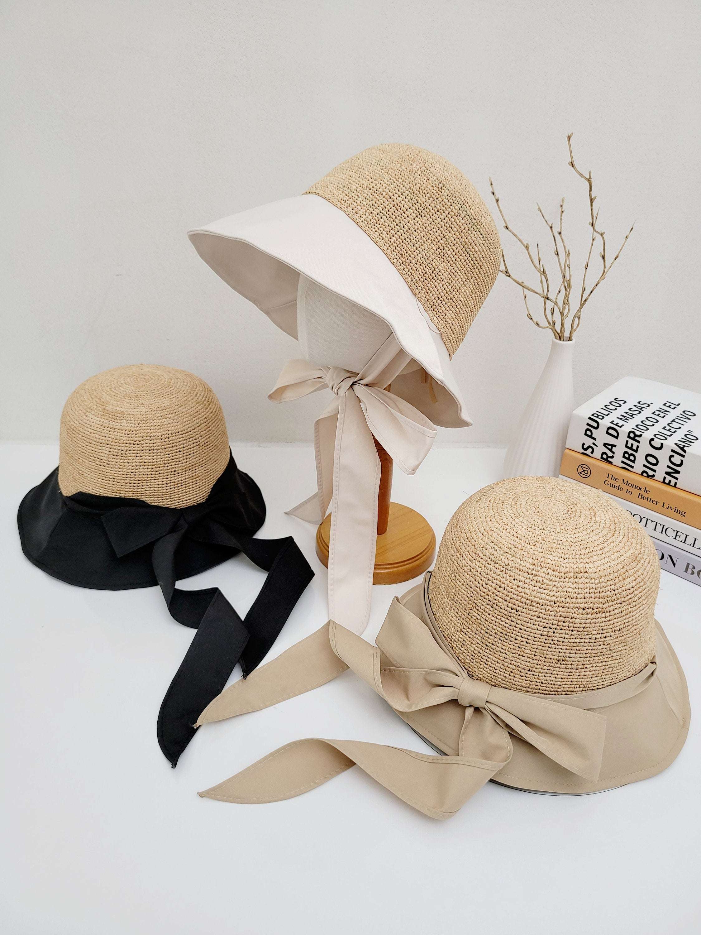 Three south hampton straw sun hats: black, beige, and white brim variations with matching ribbon ties, offering stylish sun protection.