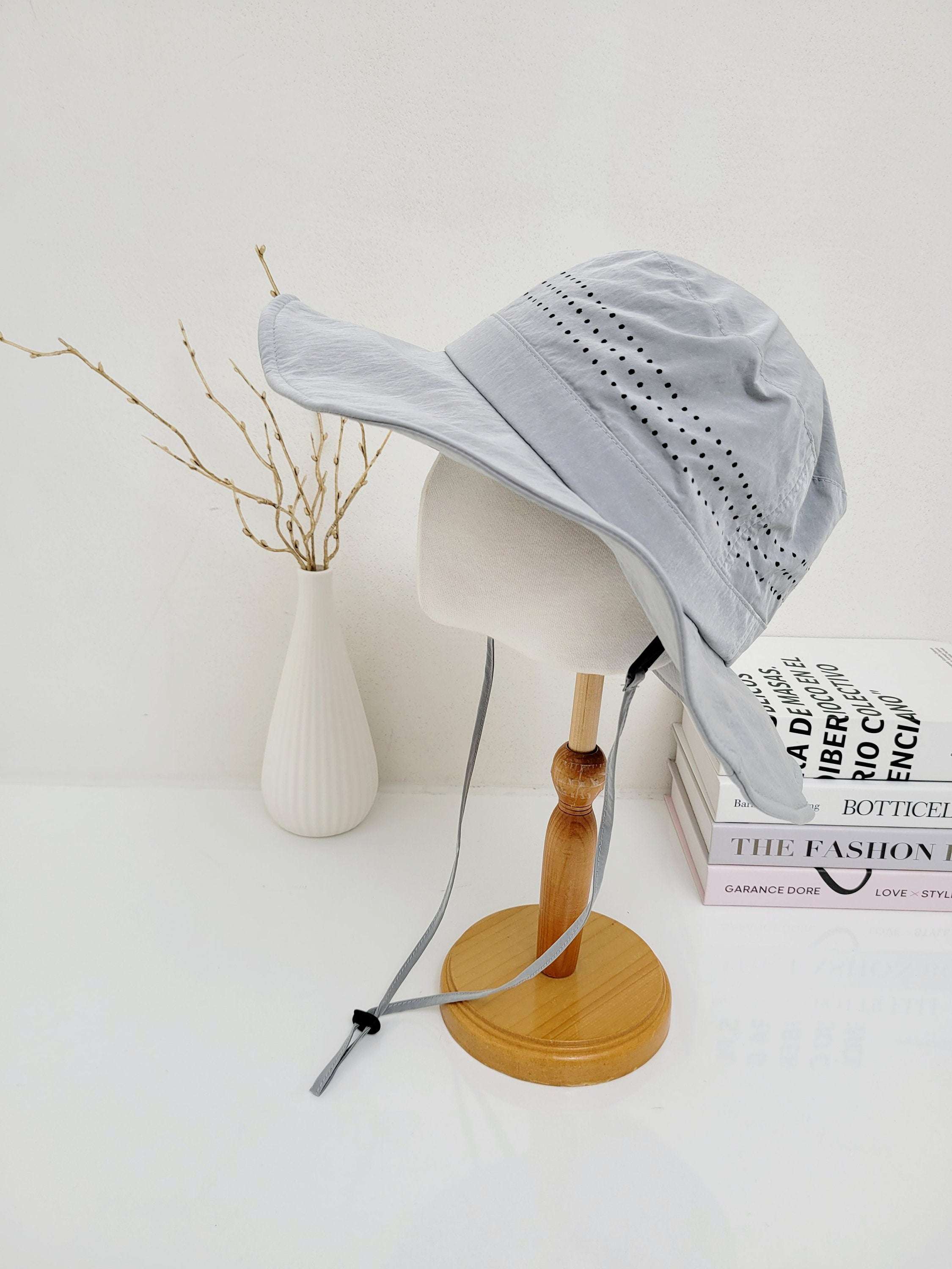 Light blue long journey sun hat with neck flap and adjustable chin strap, displayed on a mannequin head.