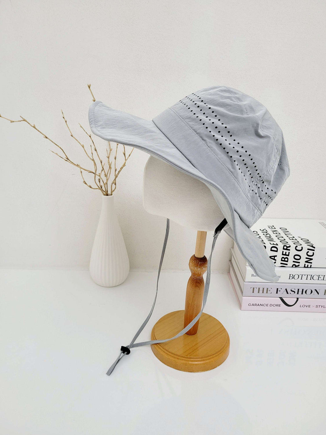 Light blue long journey sun hat with neck flap and adjustable chin strap, displayed on a mannequin head.