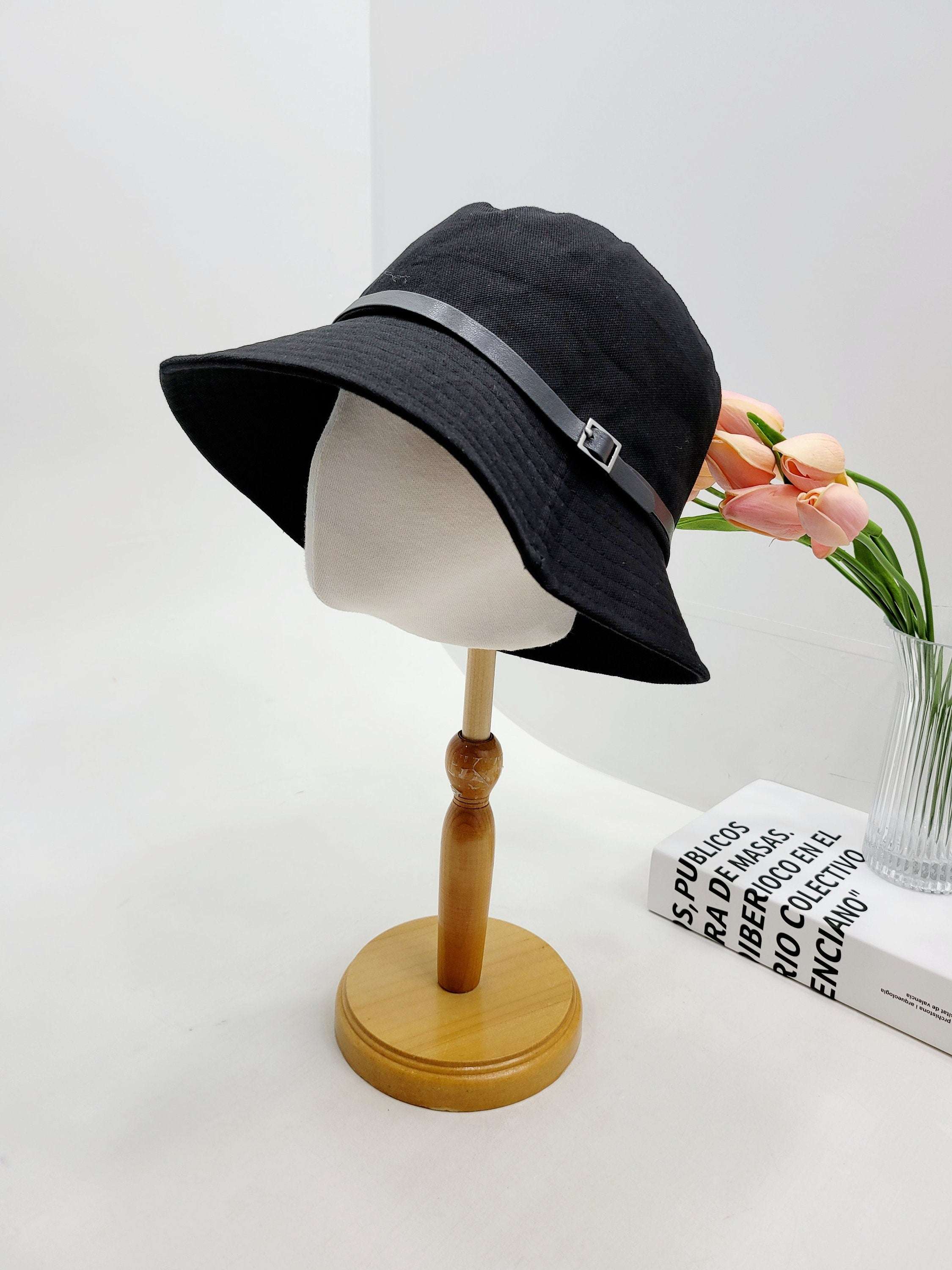 MILES black bucket hat with faux leather strap & buckle detail. Stylish sun hat for women's fashion.