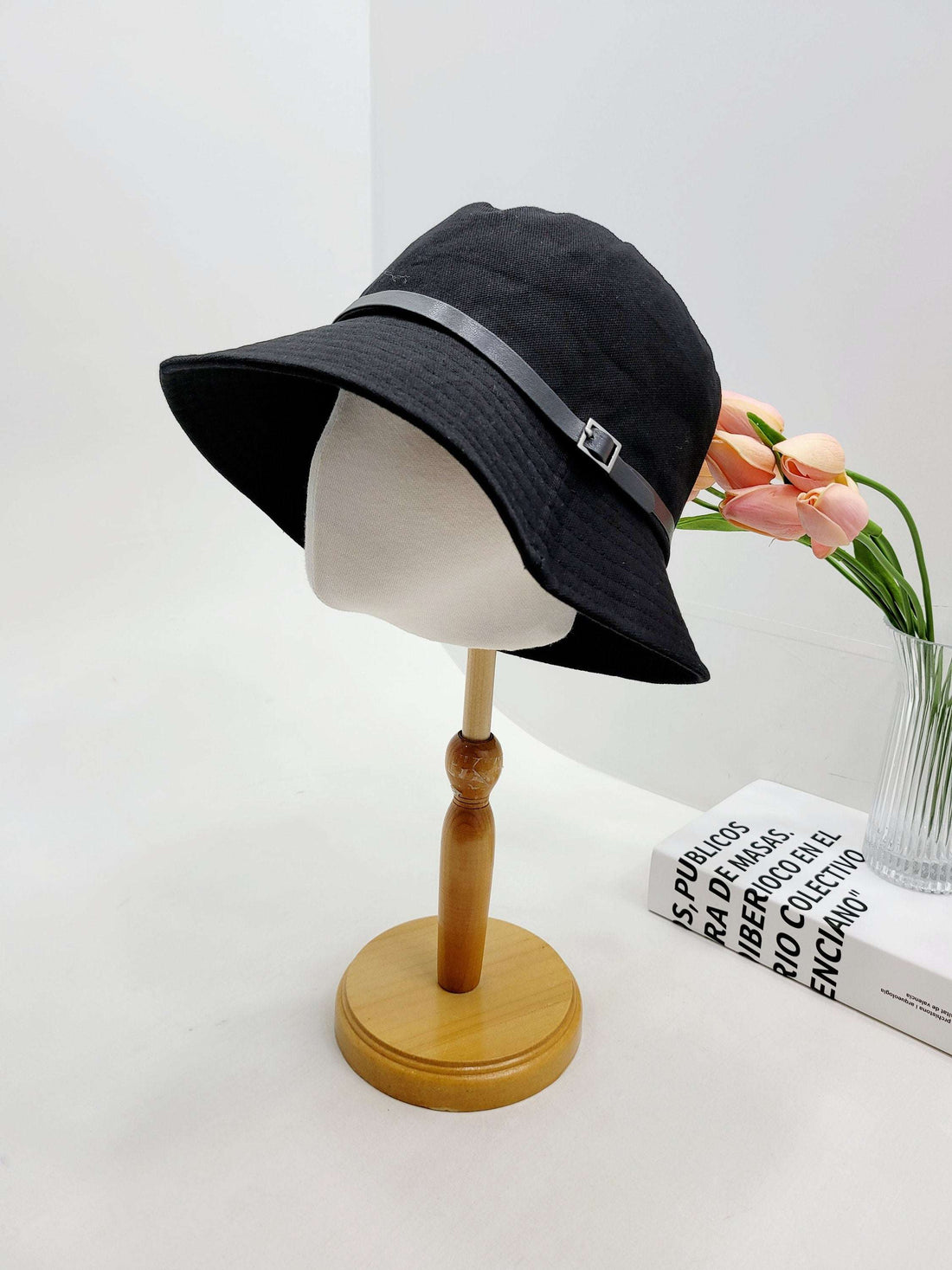 MILES black bucket hat with faux leather strap & buckle detail. Stylish sun hat for women's fashion.