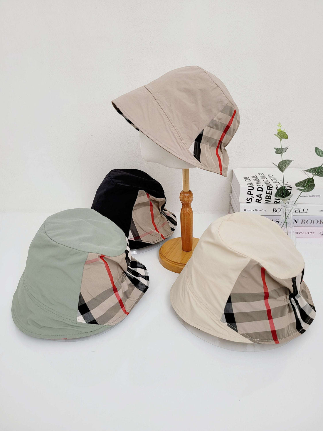 SALT LAKE bucket hats: Beige, black, green, and cream casual hats with a distinctive plaid accent, offering stylish sun protection.