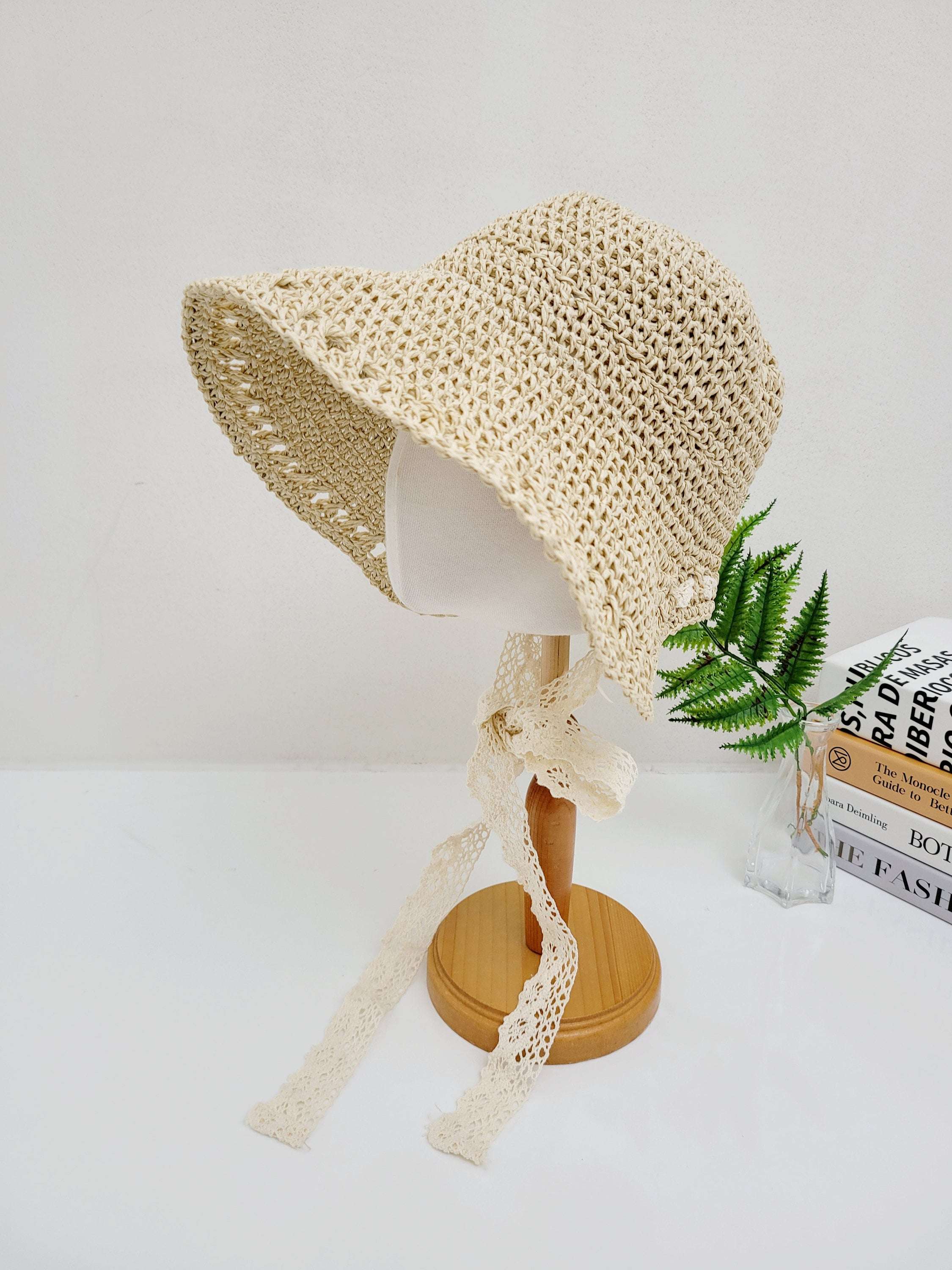 Bora Bora sun hat: woven straw hat with wide brim, lace ribbon tie, and light, airy design—perfect for sun protection and stylish flair.