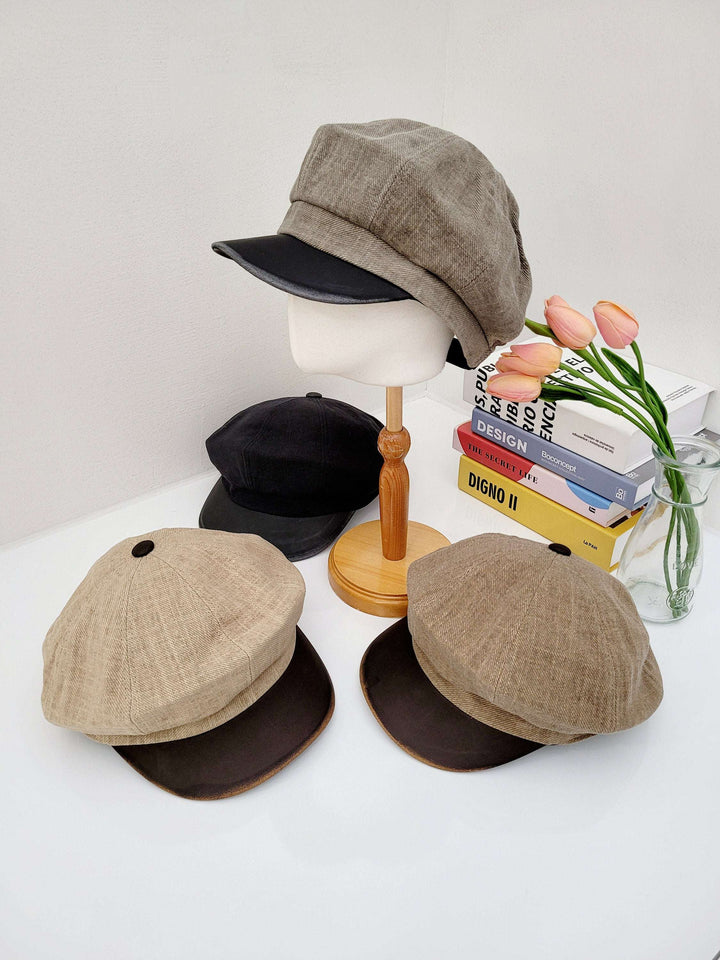 lana beret assortment: newsboy caps in brown tweed, beige linen, and solid black. Stylish hats displayed with books and tulips.