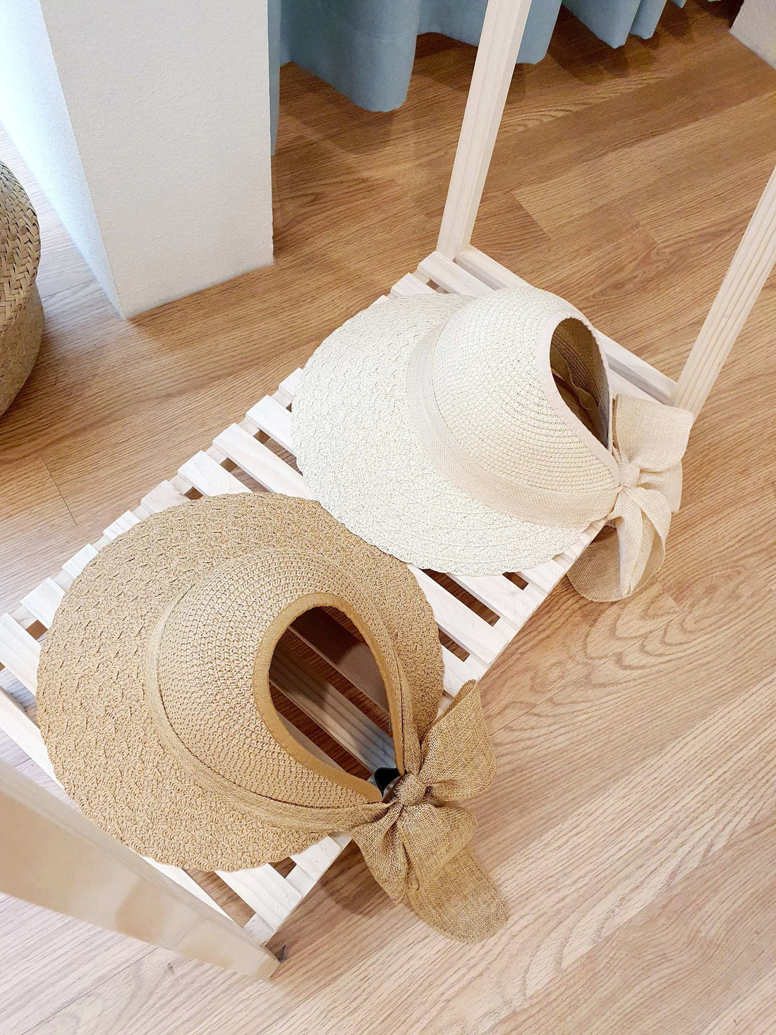 the big island sun hats: A beige and a cream straw hat with wide brim and bow detail, perfect beach hats for summer sun protection.