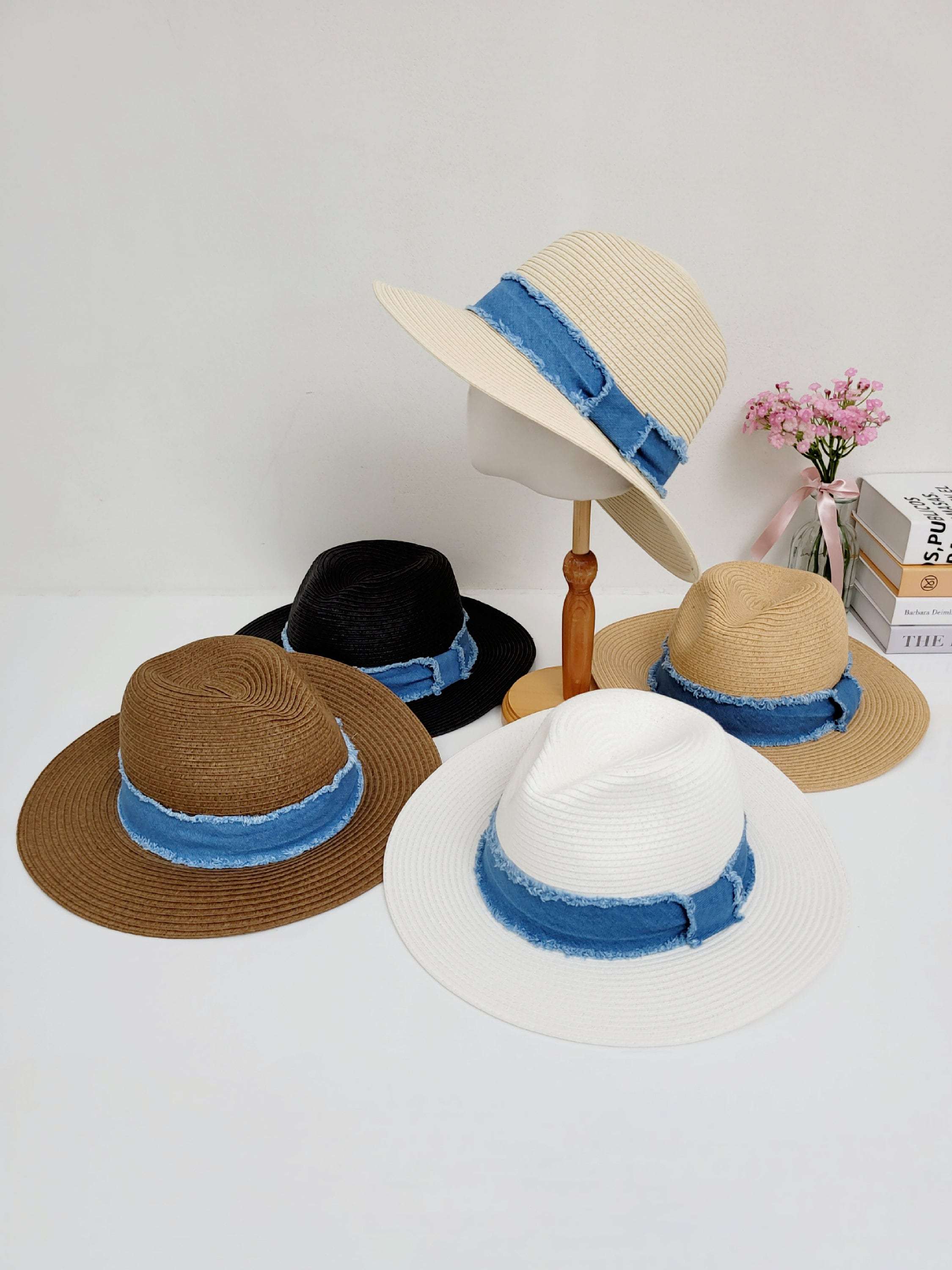 Five long island sun hats in white, black, brown, tan, and beige, each featuring a stylish denim band. Perfect for sun protection and a fashionable look.