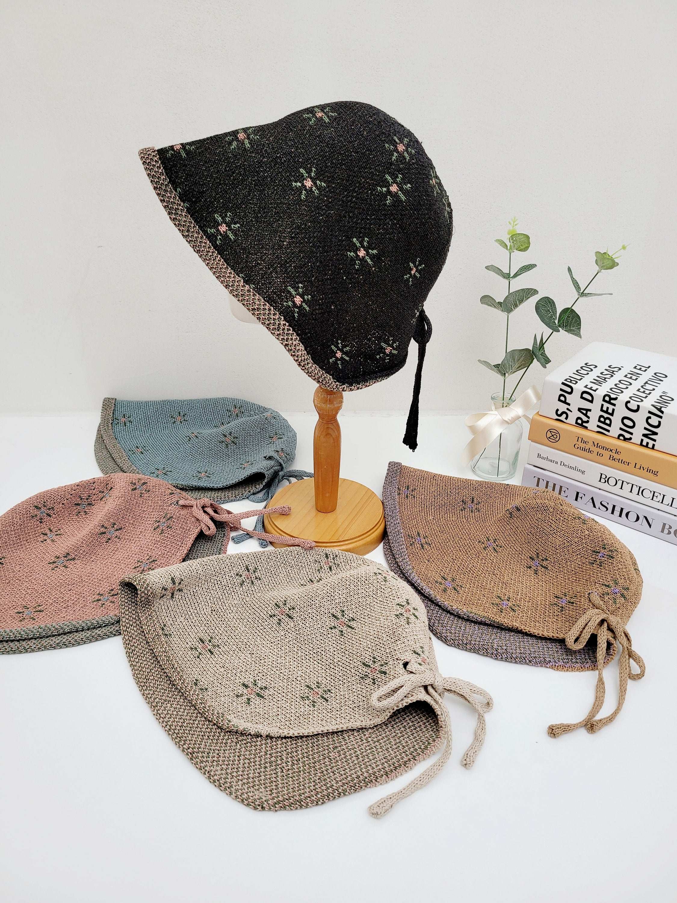 emma floral bonnets: A collection of cute, patterned sun hats in various colors, perfect for sun protection and adding a touch of vintage style.
