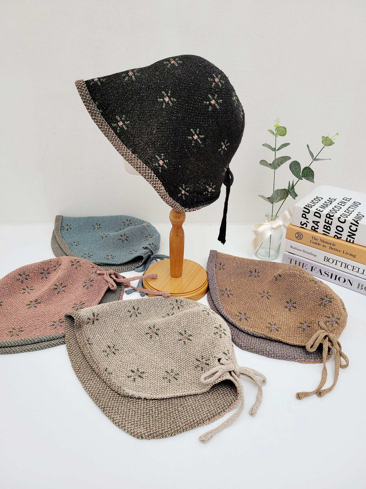emma floral bonnets: A collection of cute, patterned sun hats in various colors, perfect for sun protection and adding a touch of vintage style.