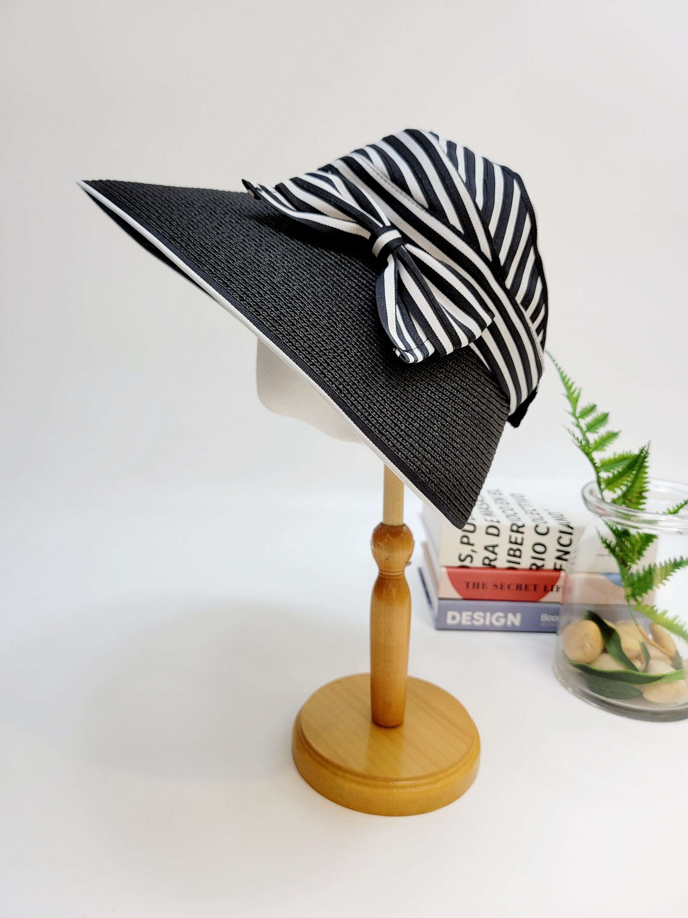 monroe: black sun hat with a striking black and white striped bow detail, offering stylish sun protection