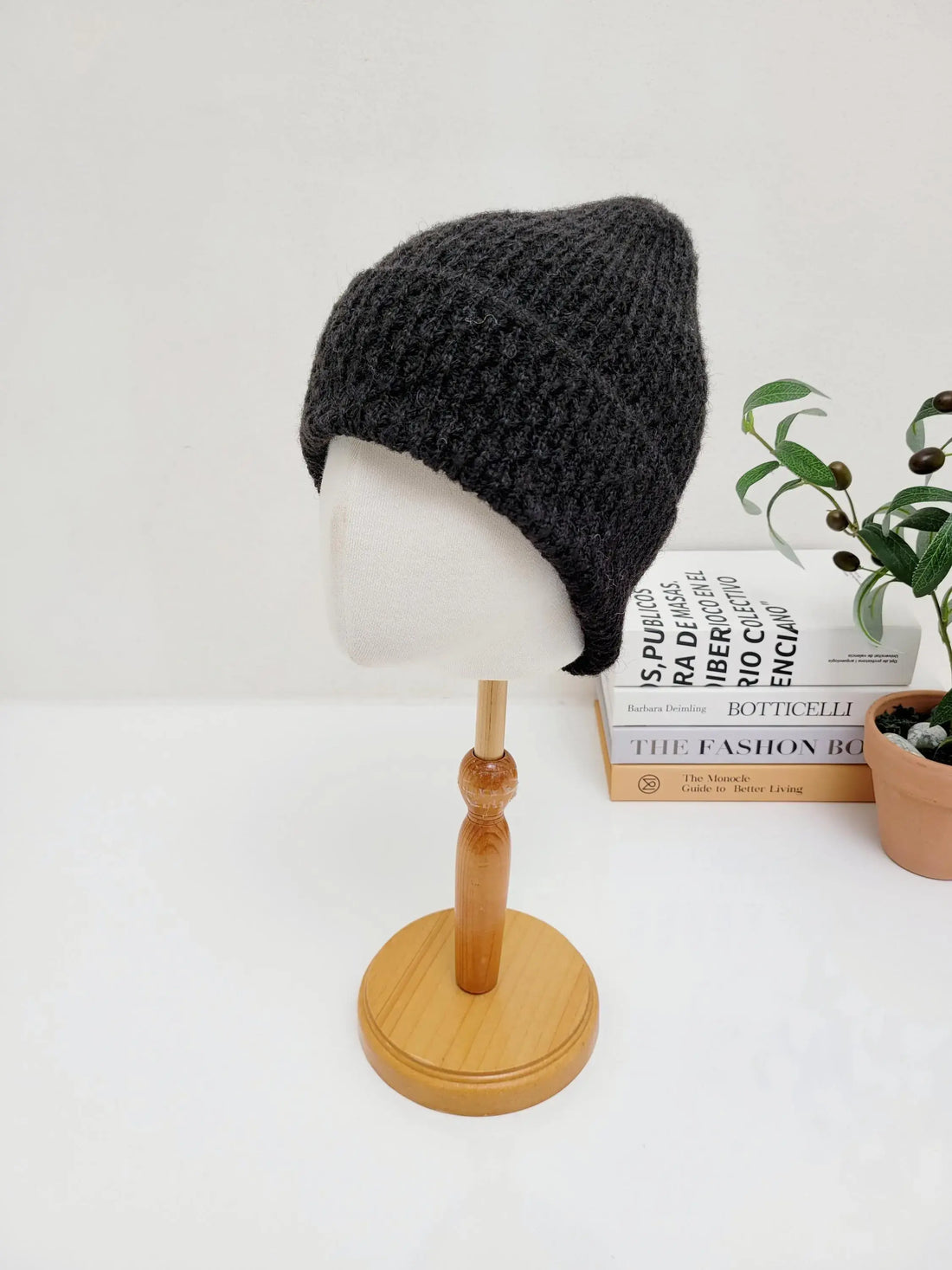 Dark gray knitted TAYLOR beanie hat on display. Soft, textured knit provides warmth and comfort.