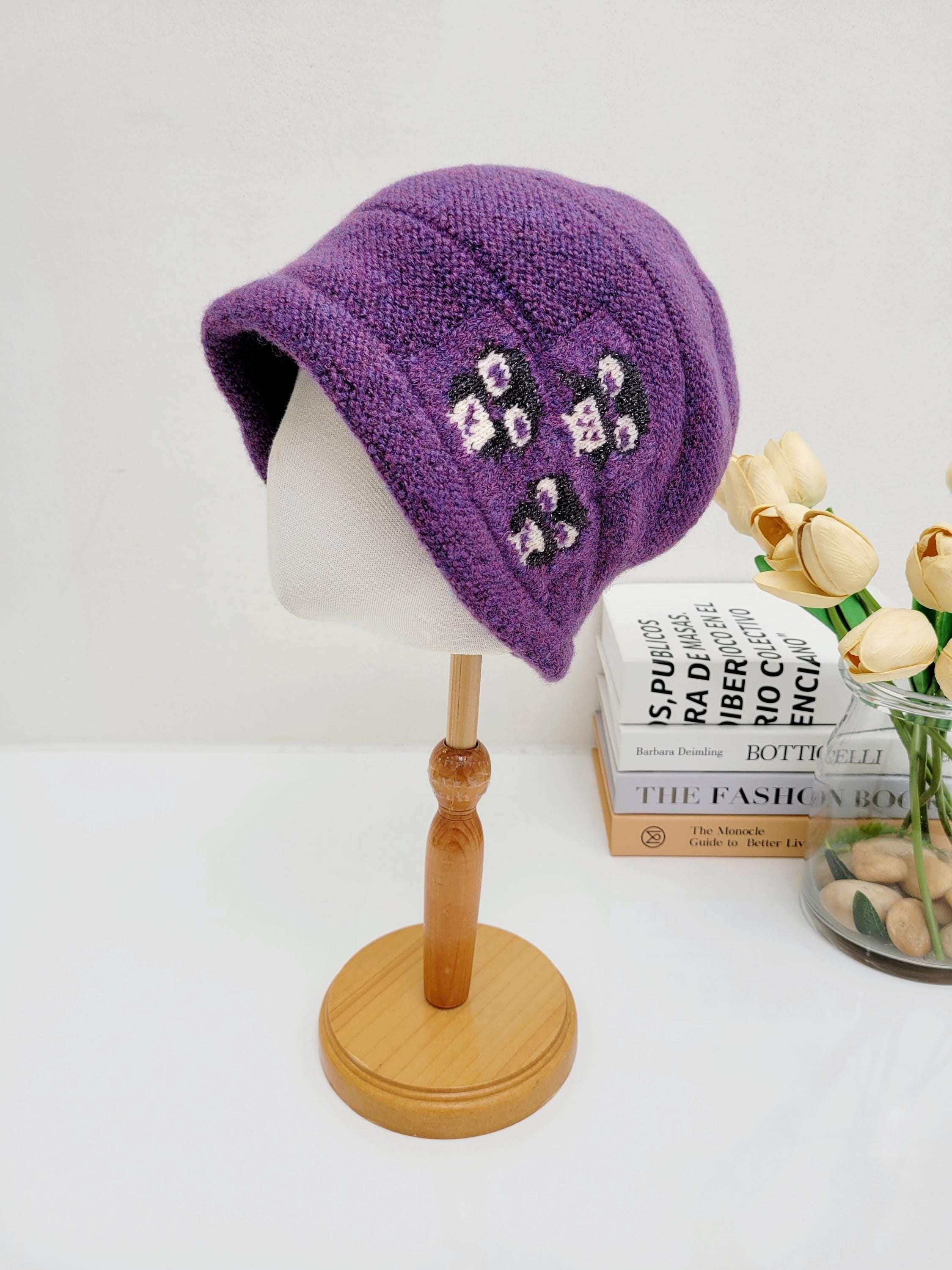 Purple penguin slouch beanie knit hat with floral embroidery detail, displayed on a mannequin head