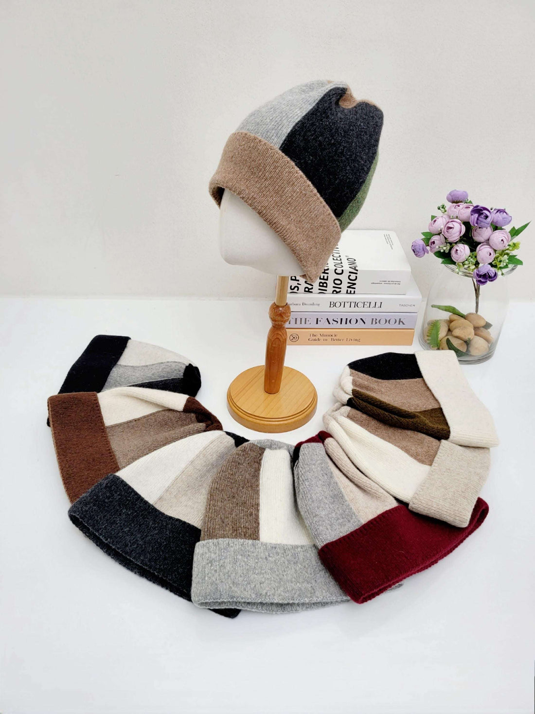 Color block wool beanie hats in brown, gray, black, cream, and burgundy. A mannequin displays one of the cozy, stylish beanies.