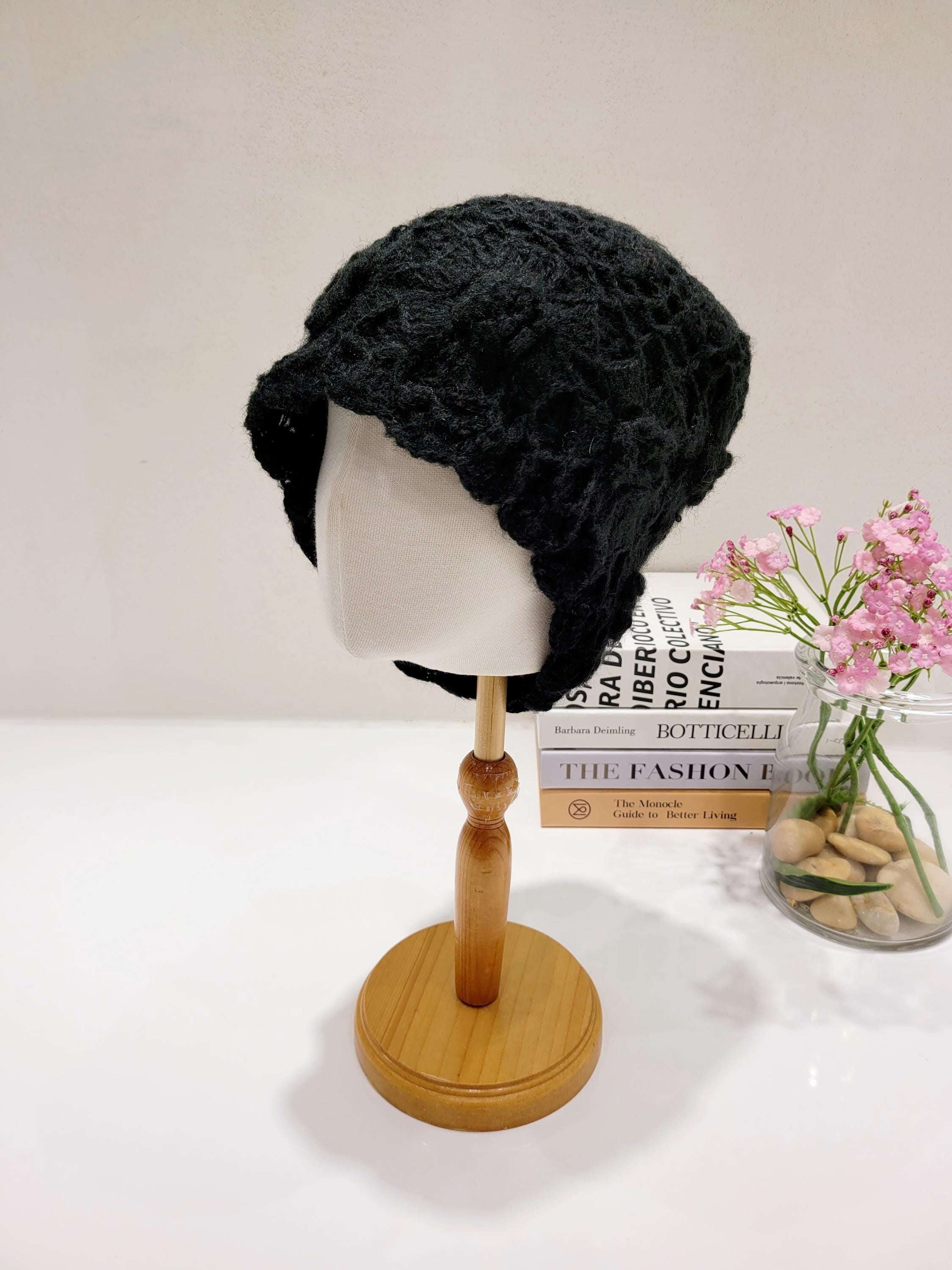 Black sharon beanie knit hat on a mannequin head, textured pattern with a slight brim.