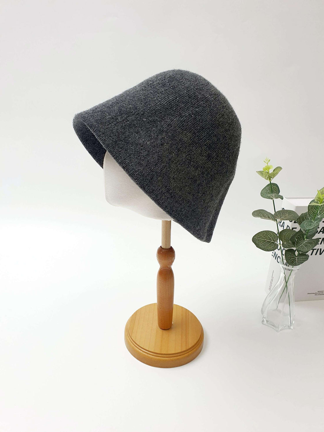 FALL'IN WINTER: Charcoal gray knitted bucket hat on a mannequin, showcasing its soft texture and stylish, relaxed fit.