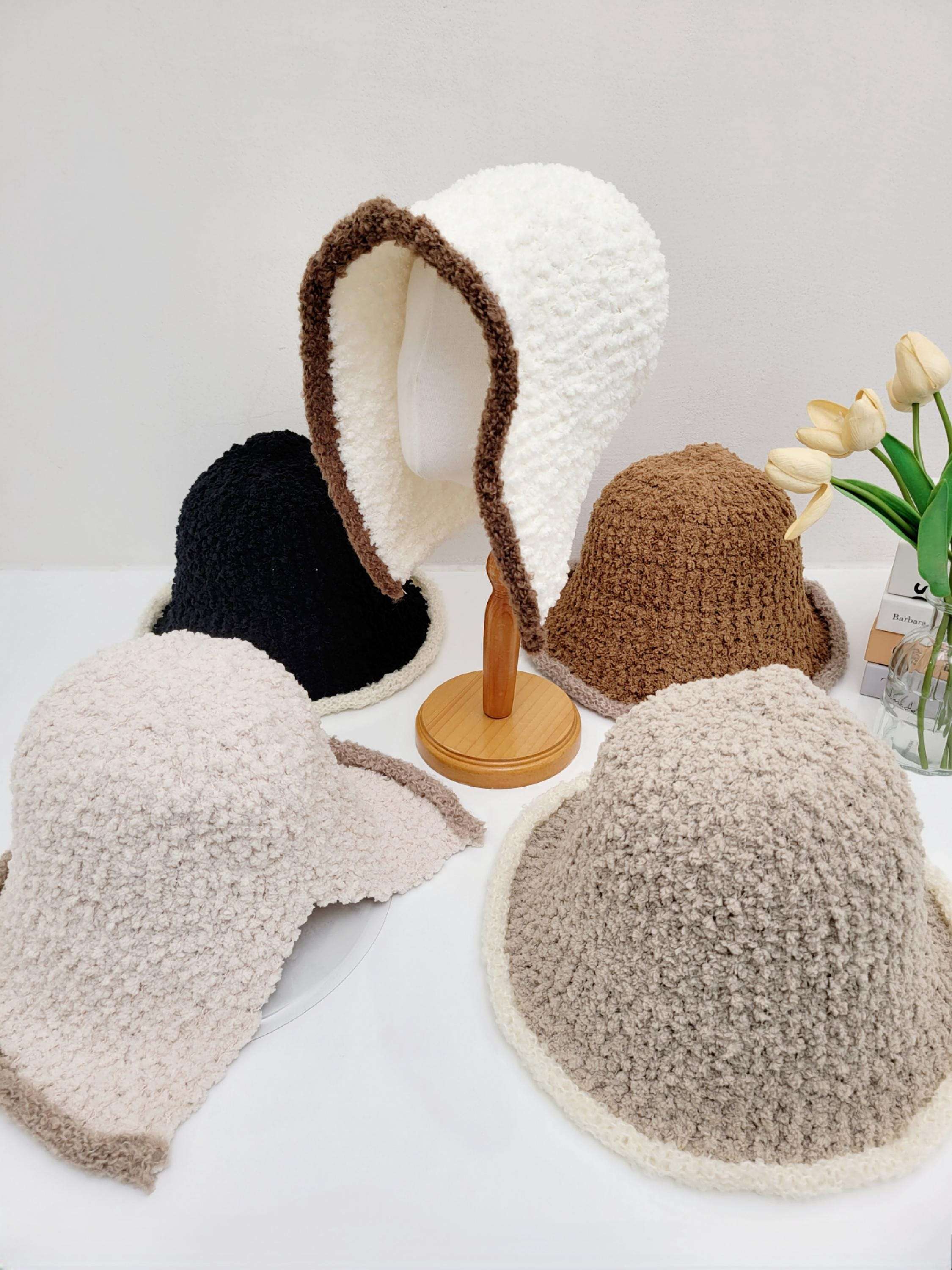 Wool hooded hat collection: textured hats in white with brown trim, black, brown, and beige. Cozy and stylish winter headwear.