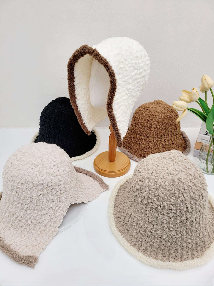 Wool hooded hat collection: textured hats in white with brown trim, black, brown, and beige. Cozy and stylish winter headwear.