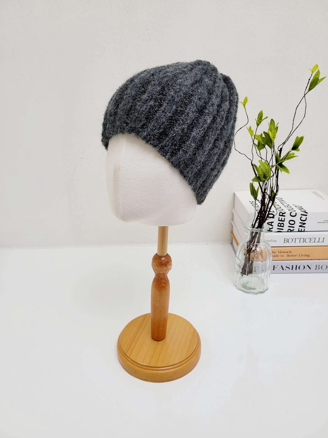 Dark gray wide rib wool beanie on a mannequin head. A warm and stylish winter hat.