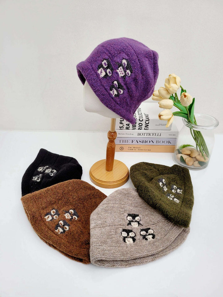 penguin slouch beanie in purple, black, brown, beige, and olive green. Each hat features a cute penguin design.
