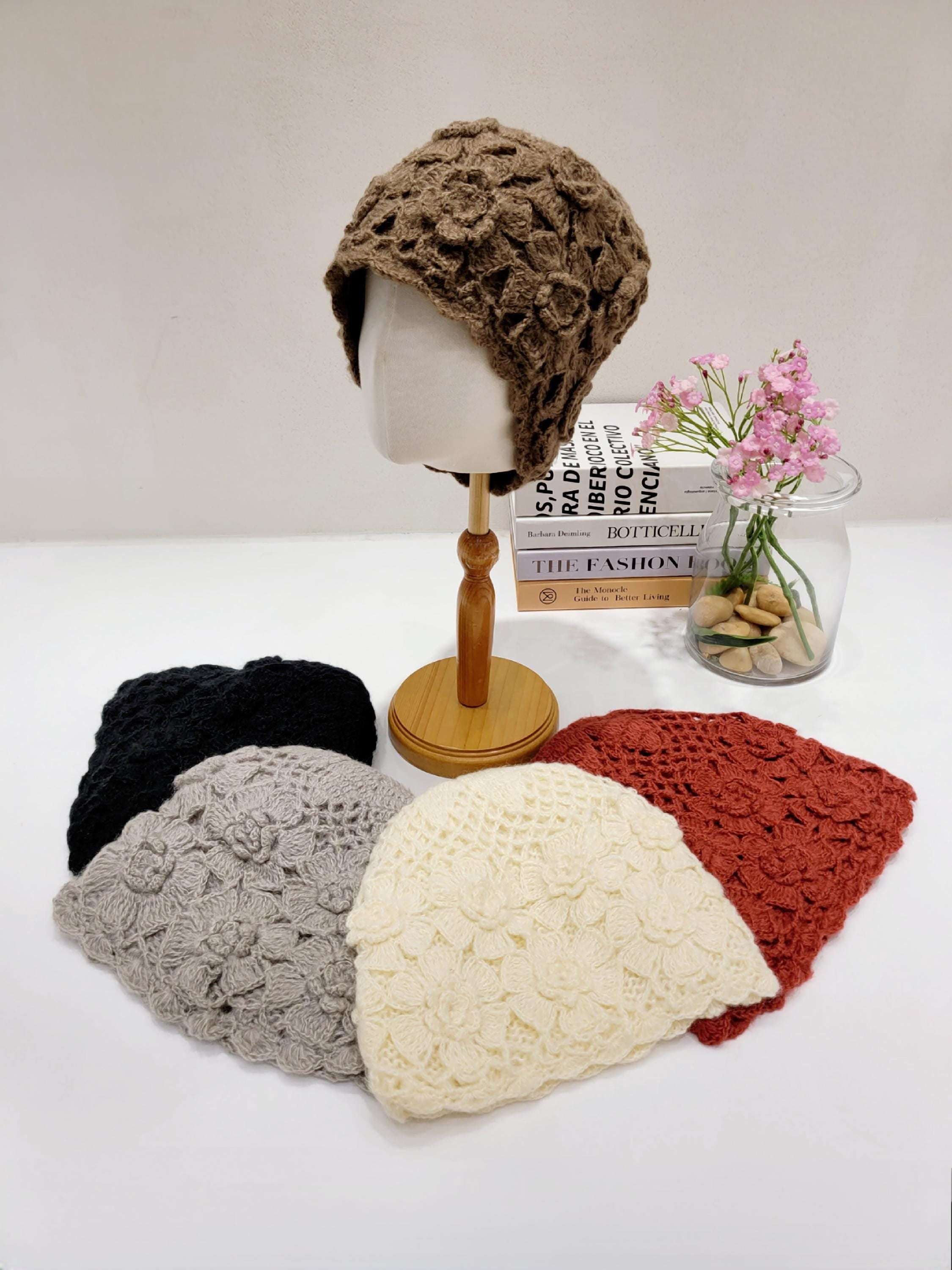 sharon beanie: Assorted crocheted beanies in brown, black, gray, cream, and rust. Each beanie features a unique floral pattern and soft, textured design.