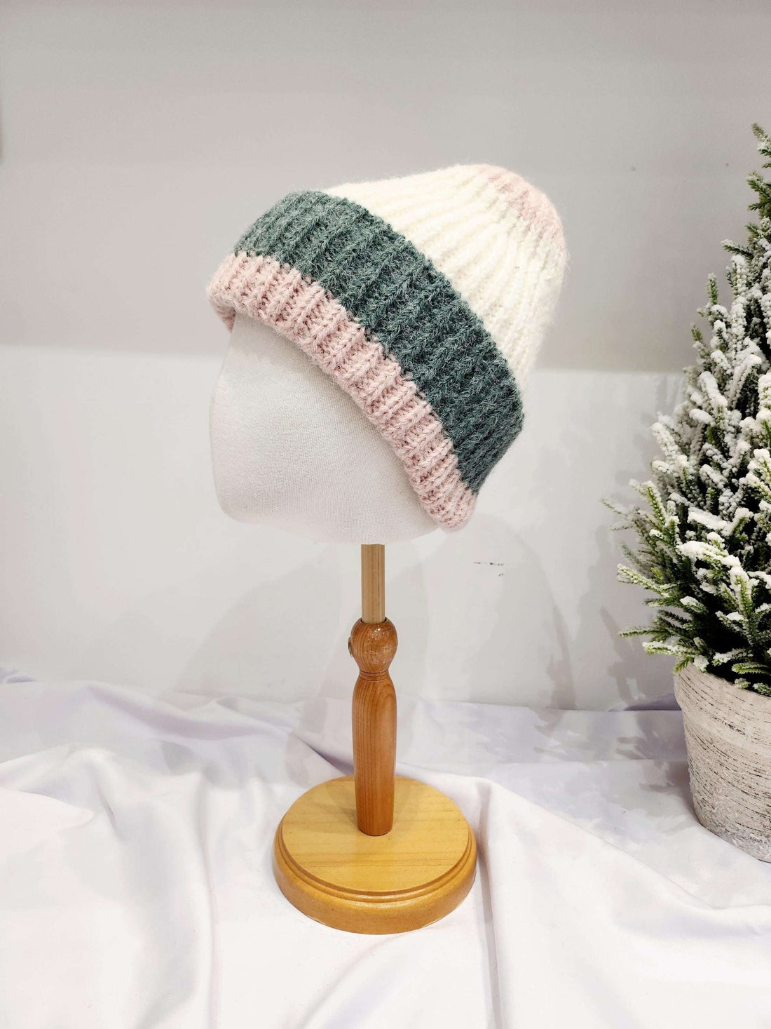 anna angora beanie: Cream, gray, and pink striped knit beanie on a mannequin head. Soft angora blend.