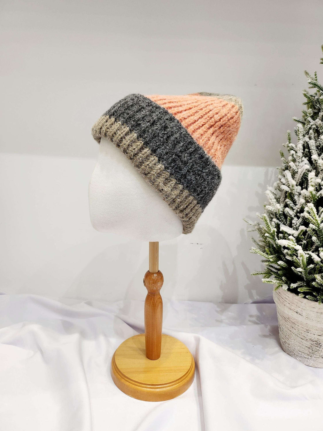 anna angora beanie: Color-blocked knitted hat with a pink crown, gray middle band, and tan brim. Angora blend for soft, warm comfort.