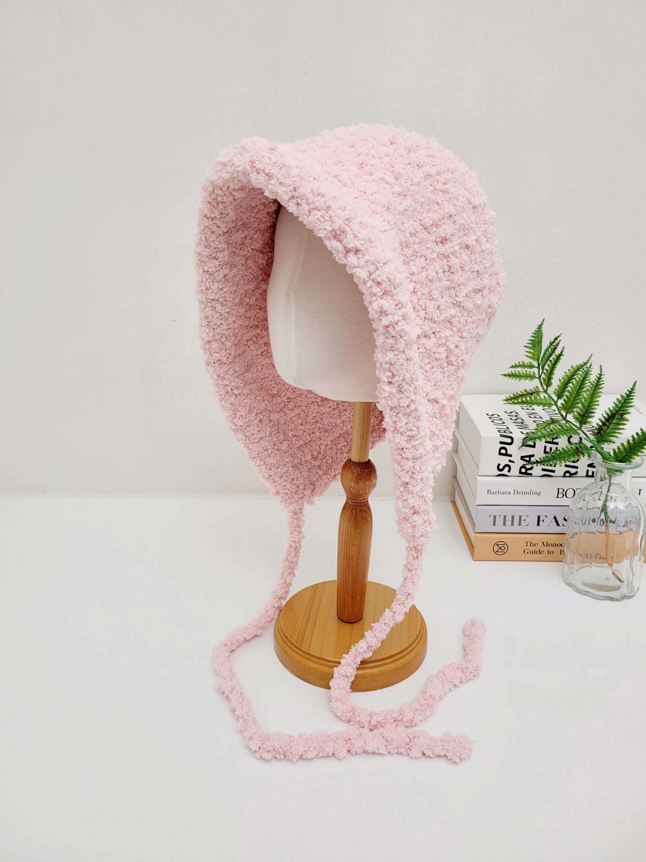 little riding hood - sherpa bonnet in soft, fuzzy pink sherpa. Features long ties and a cozy, warm design.