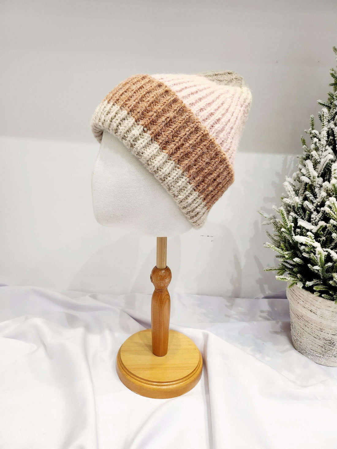 anna angora beanie: soft knitted hat with pink, brown, and cream horizontal stripes. Shown on a mannequin head.