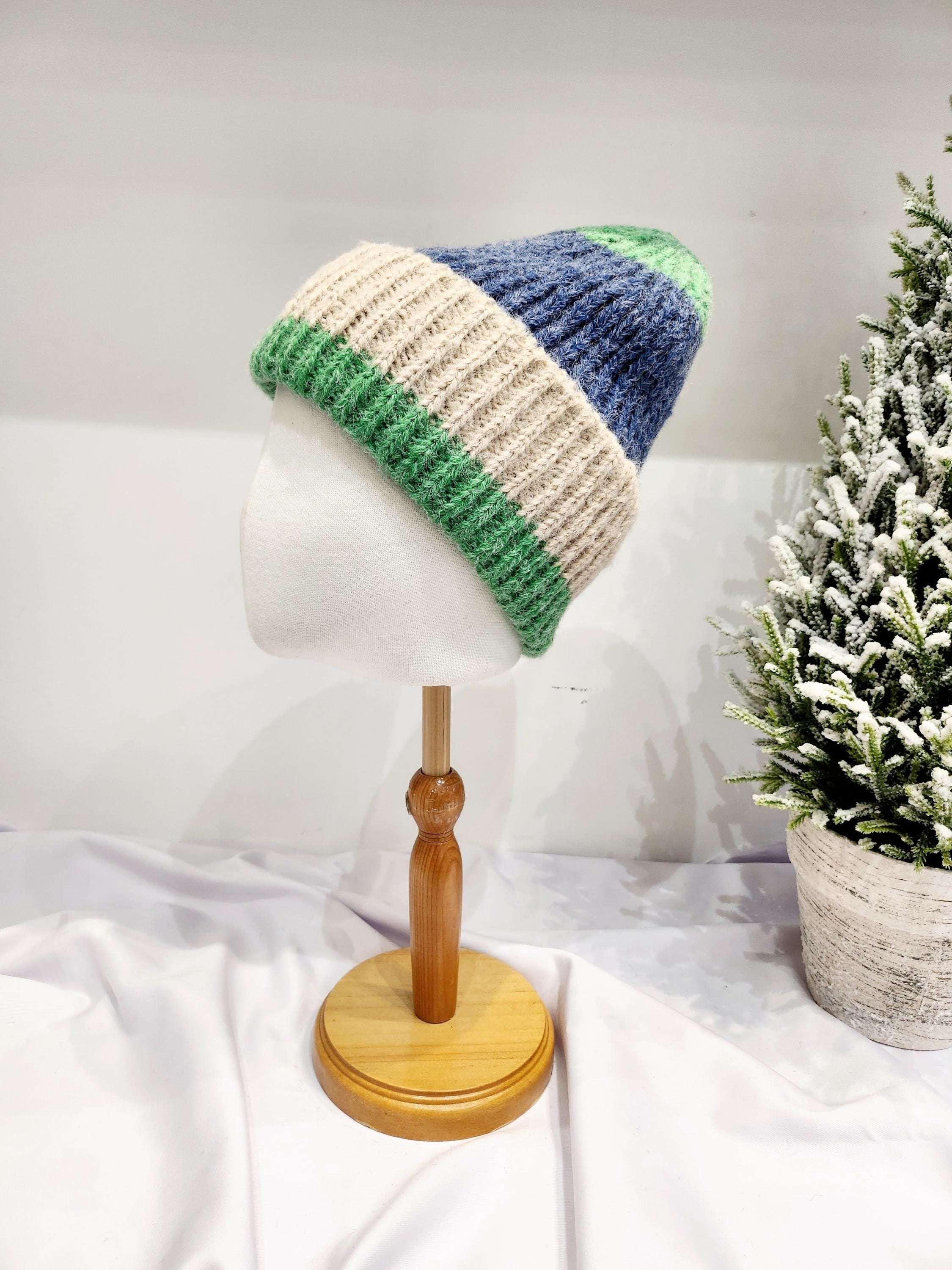 anna angora beanie: Color-blocked knit hat in green, beige, and blue. Soft, cozy, and stylish headwear on a mannequin.