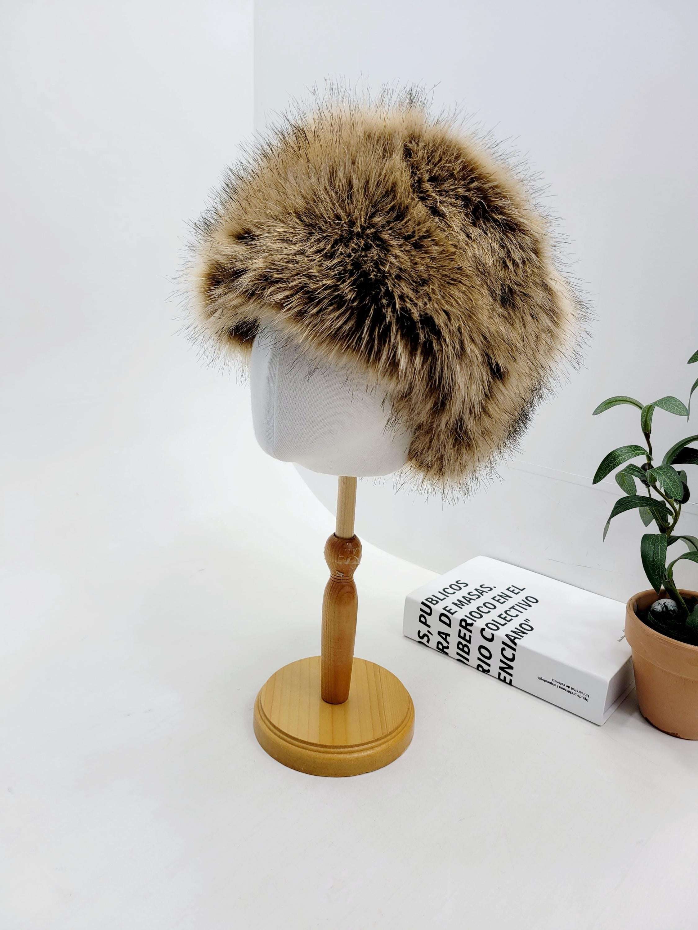 SONYA HAT FLUFFY: Round, fuzzy brown faux fur hat displayed on a mannequin head. Warm and stylish winter headwear.