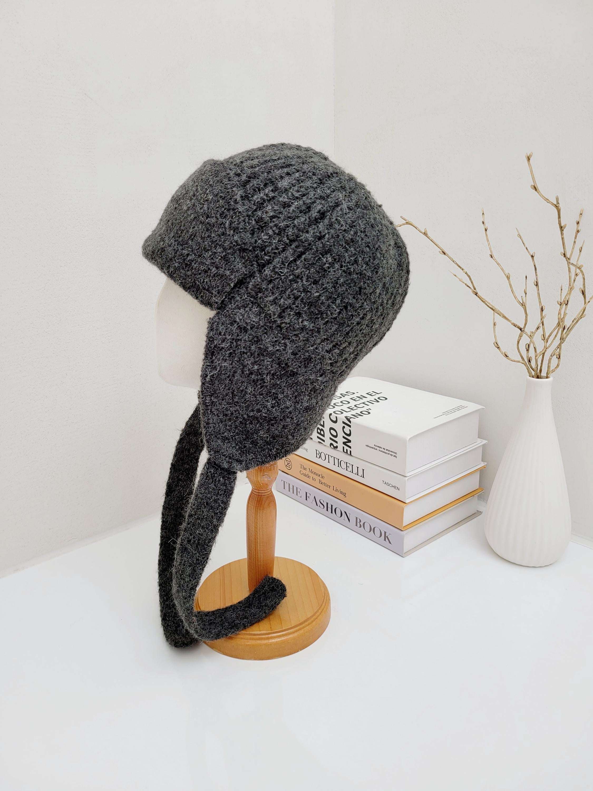 amelia gray knit hat with soft ear flaps on a mannequin head, warm and cozy for winter
